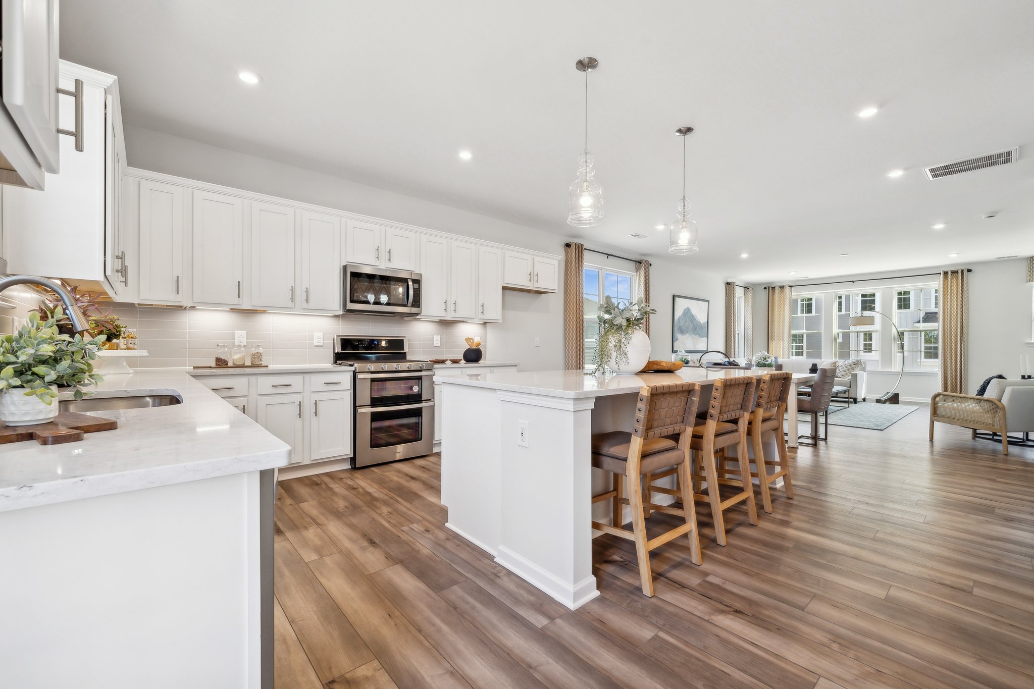 A kitchen with white cabinets.