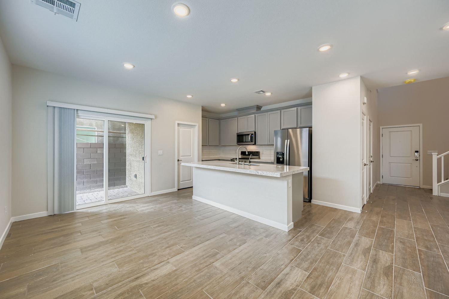 A kitchen with a wood floor.