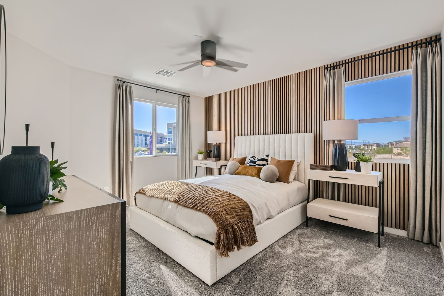 A bedroom with a bed and a fan.