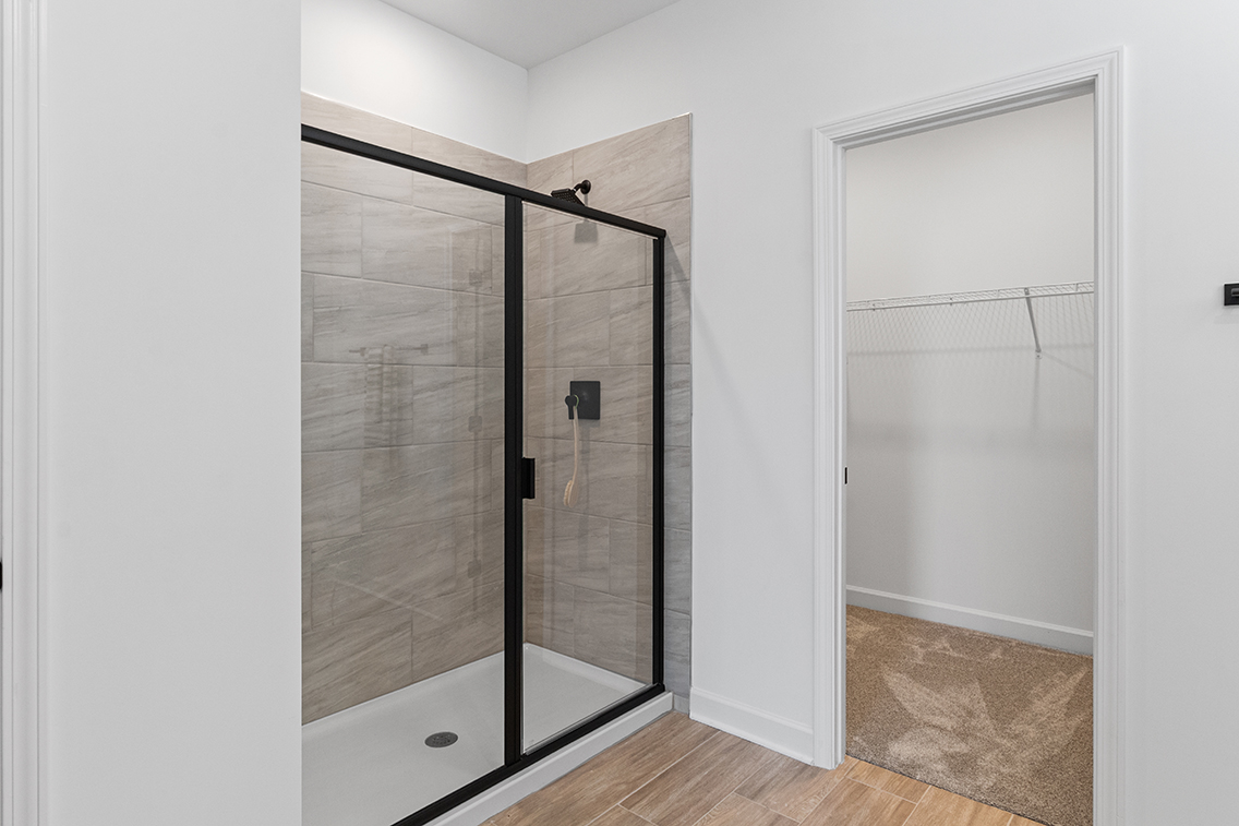 A room with a glass door and a glass shower.