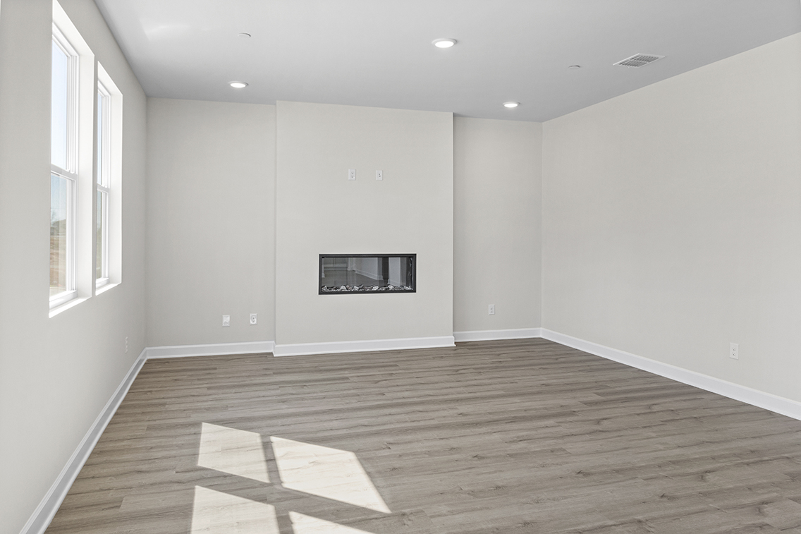 A room with a wood floor and white walls.