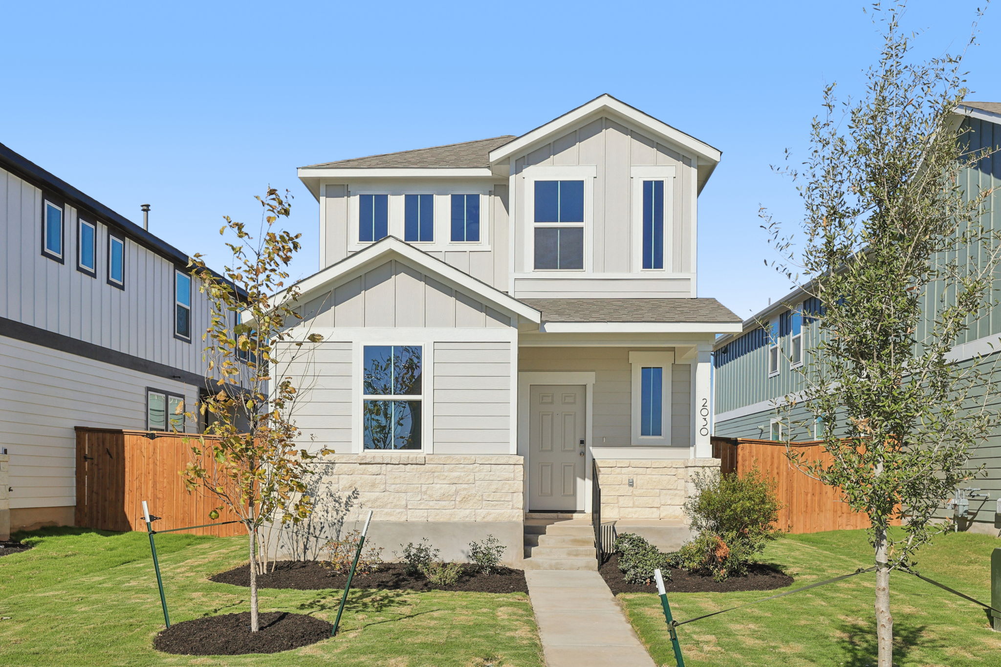 A white house with a green lawn.