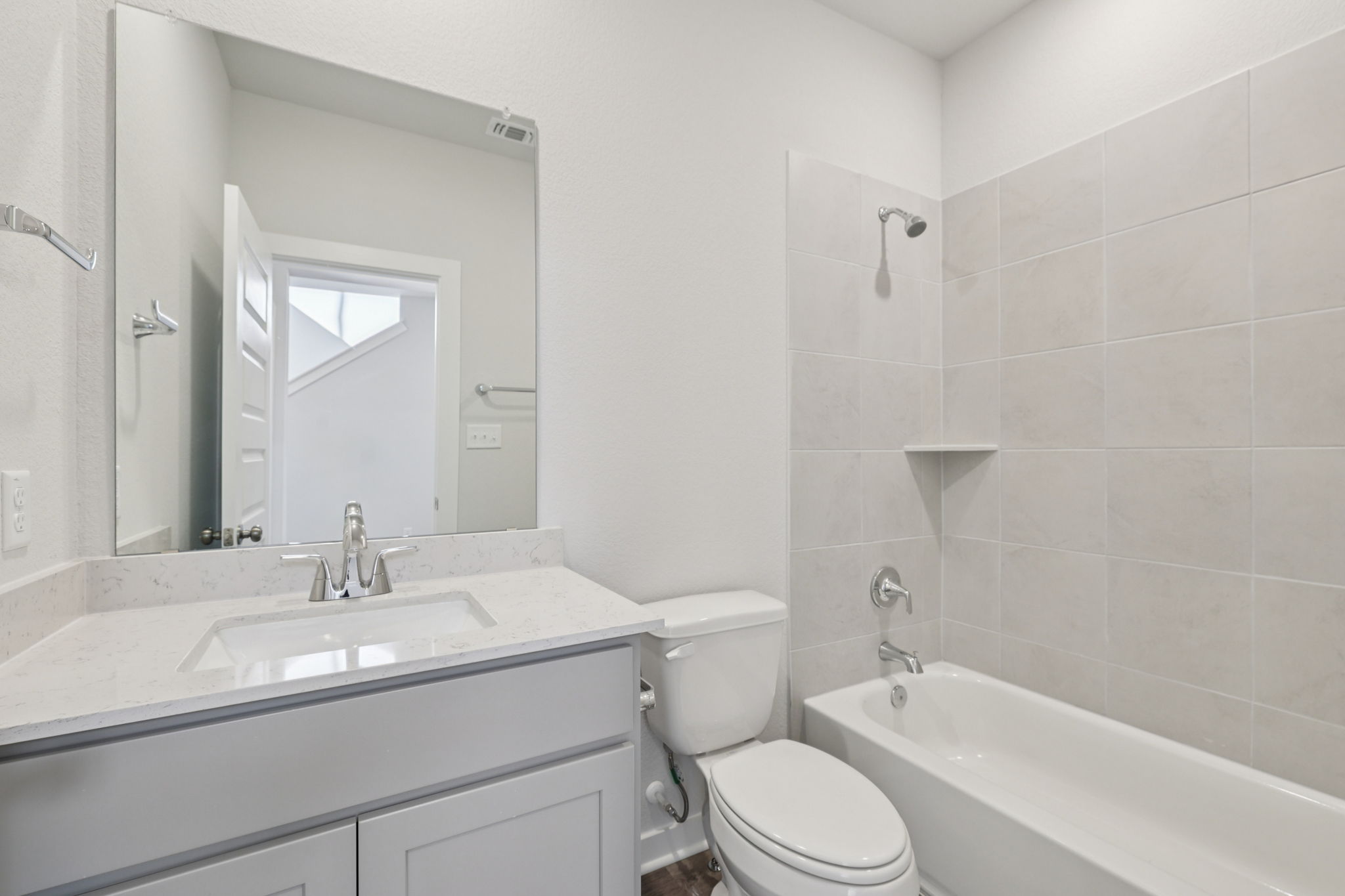A bathroom with a tub sink and toilet.