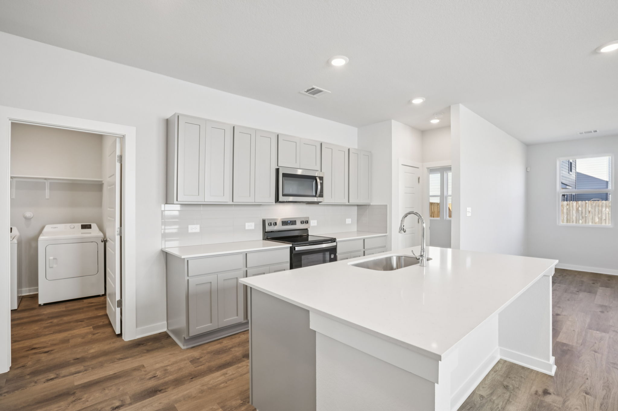 A kitchen with white cabinets.