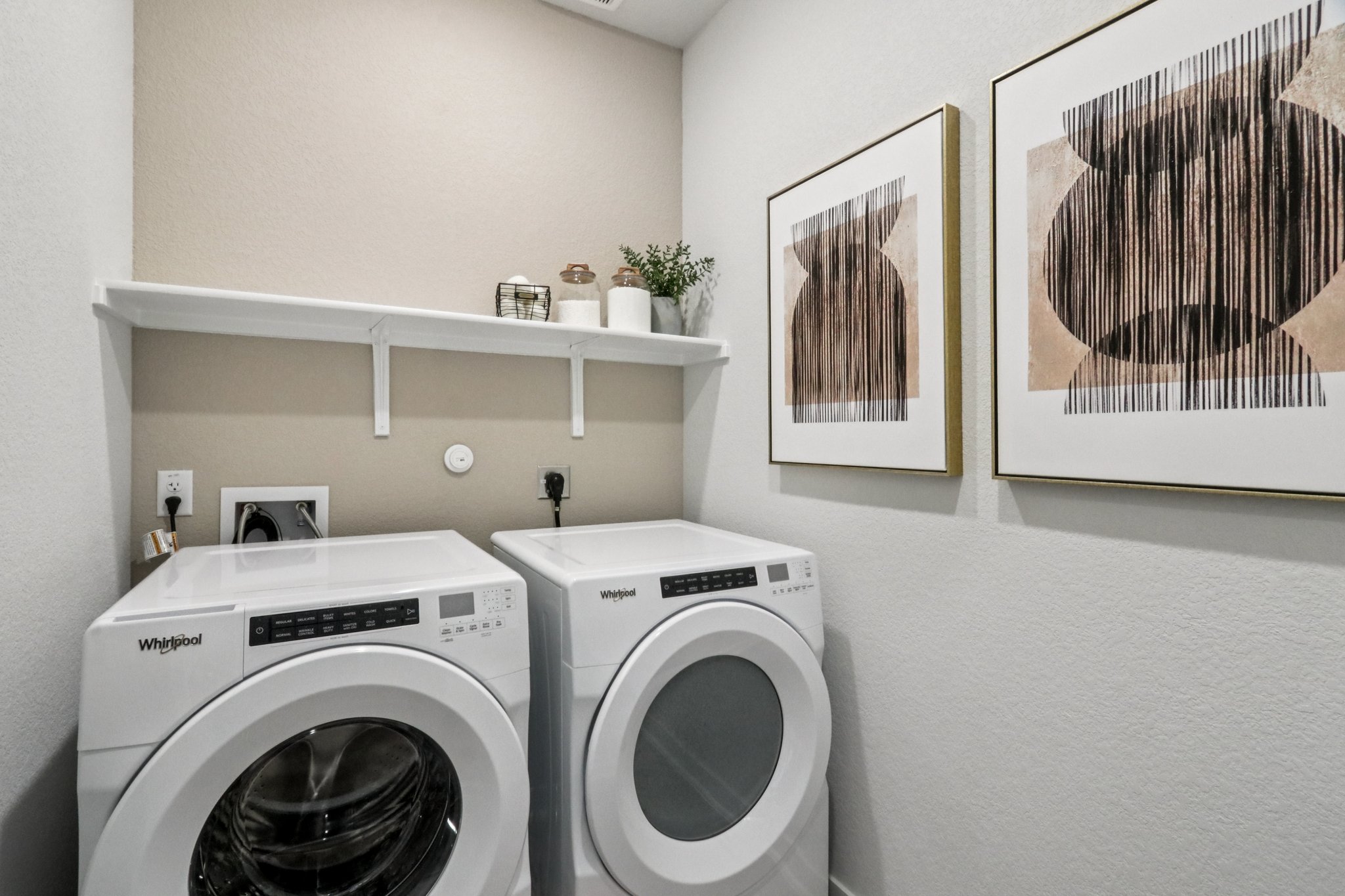 A washing machine and dryer in a room.