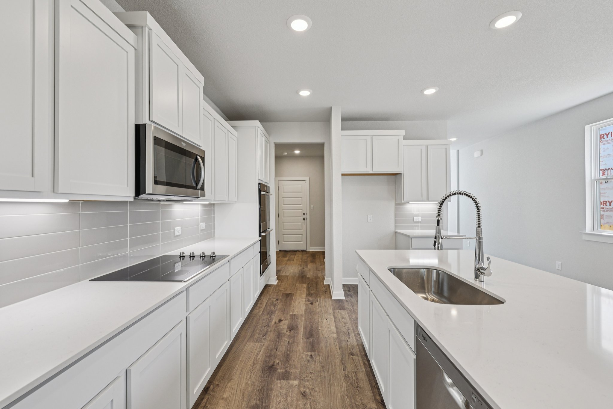 A kitchen with white cabinets.