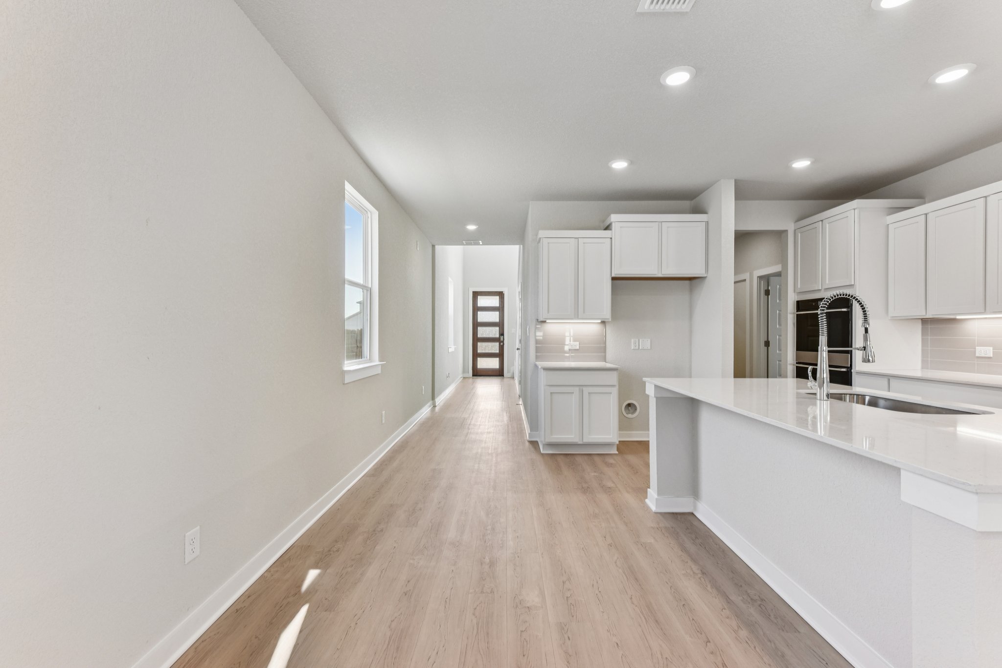 A kitchen with white cabinets.
