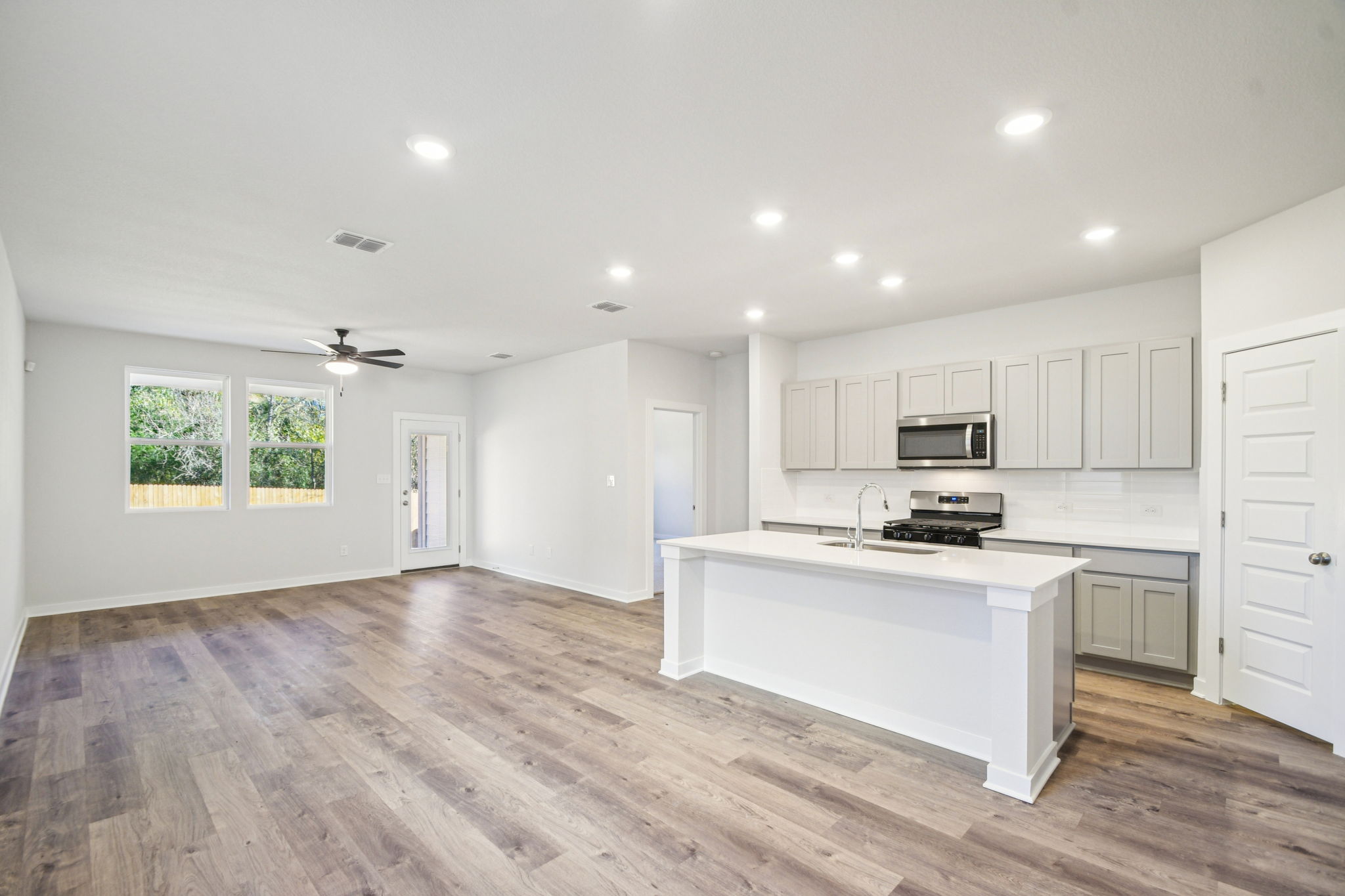 A kitchen with white cabinets.