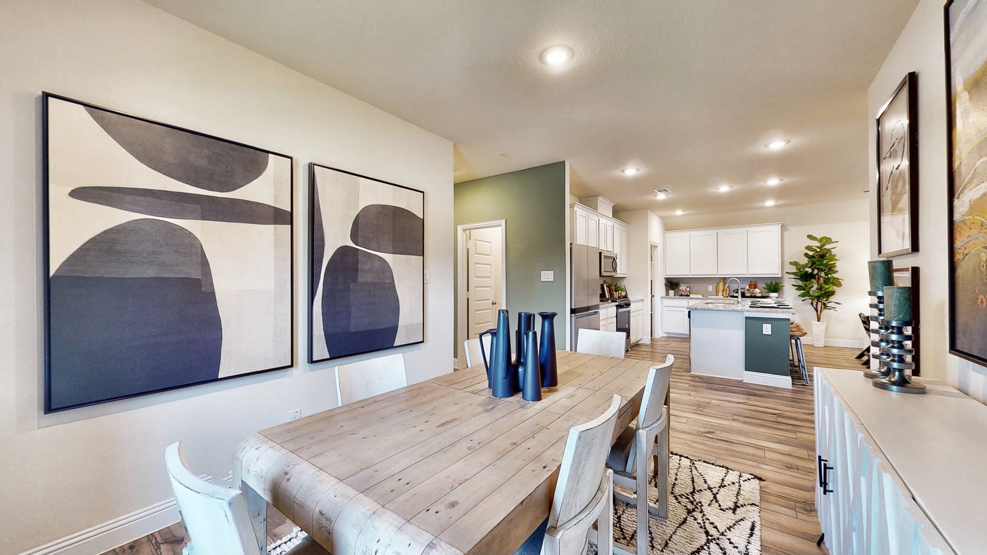 A dining room with a table and chairs.