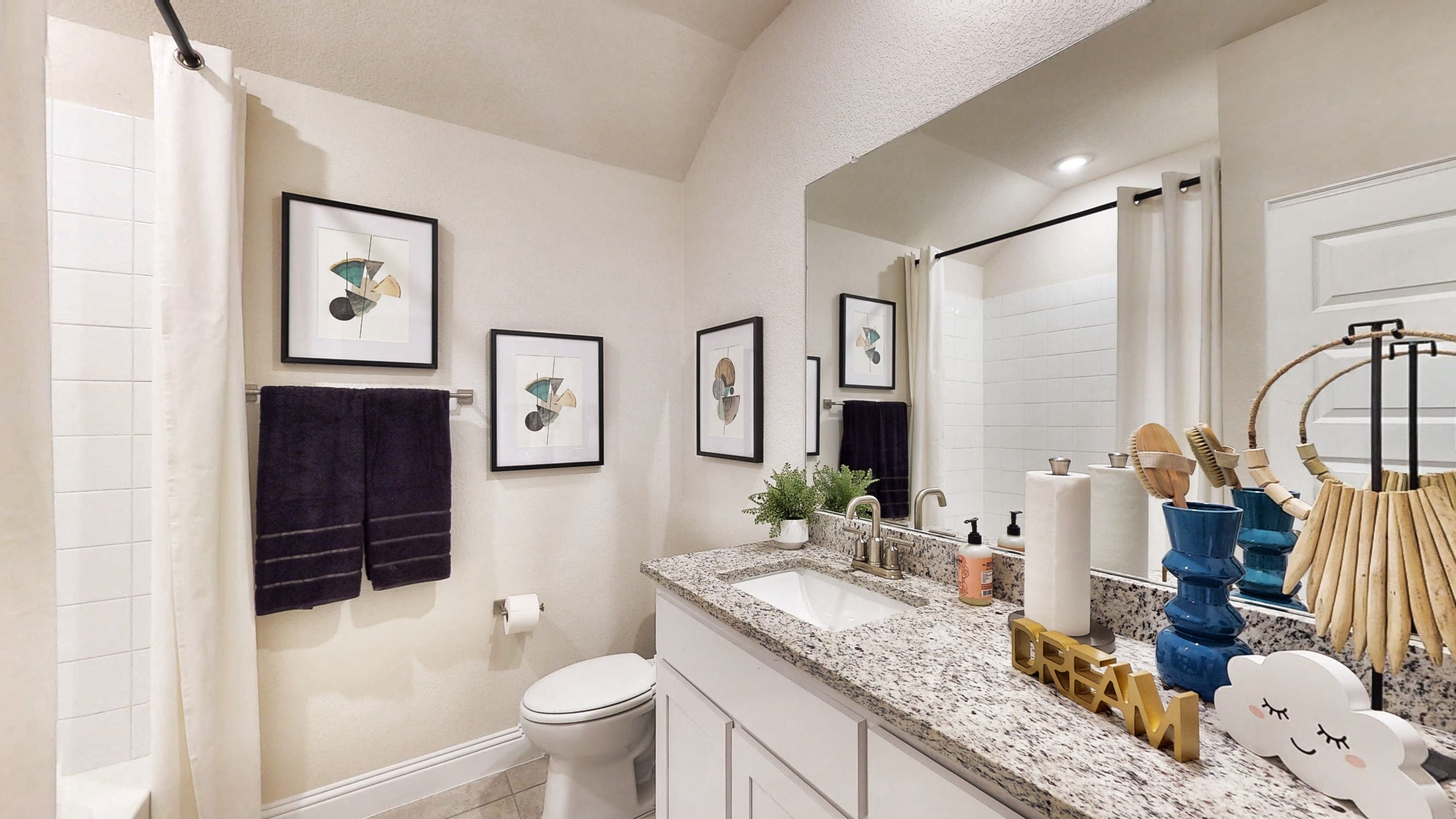 A bathroom with a large mirror.