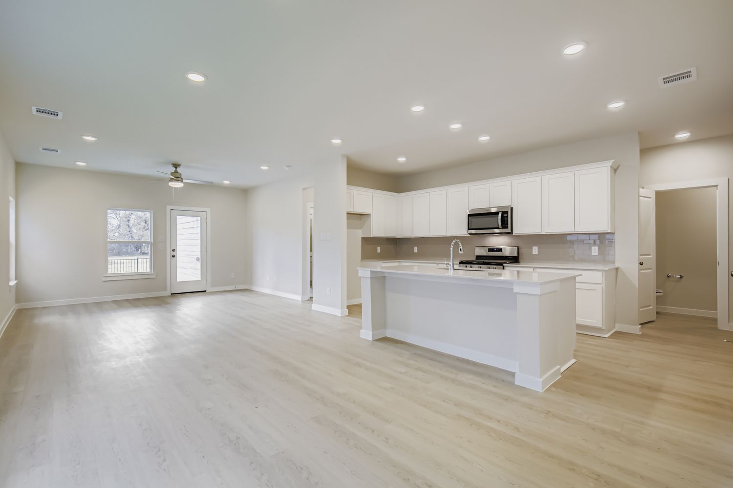A large kitchen with white cabinets.