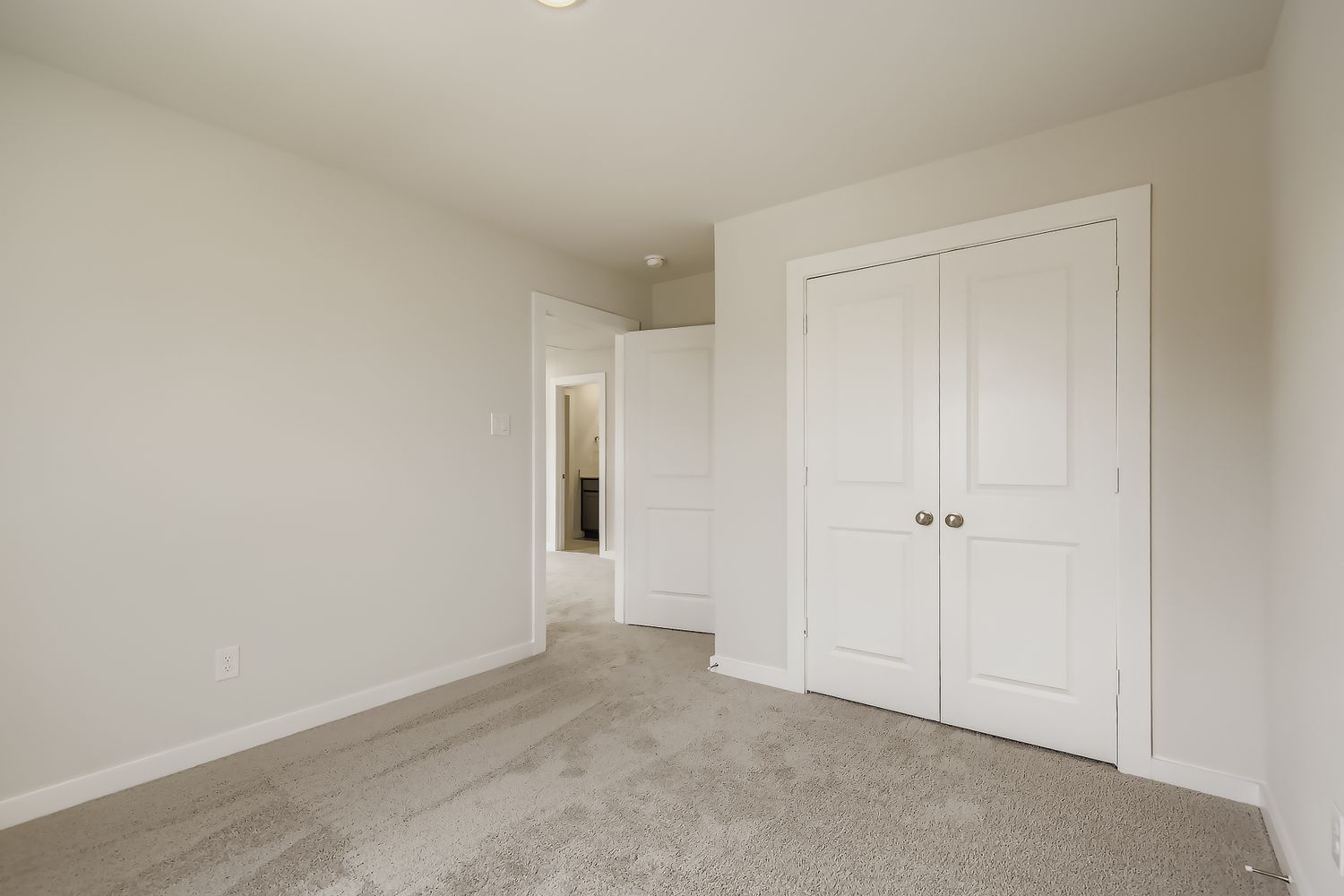 A hallway with white doors.