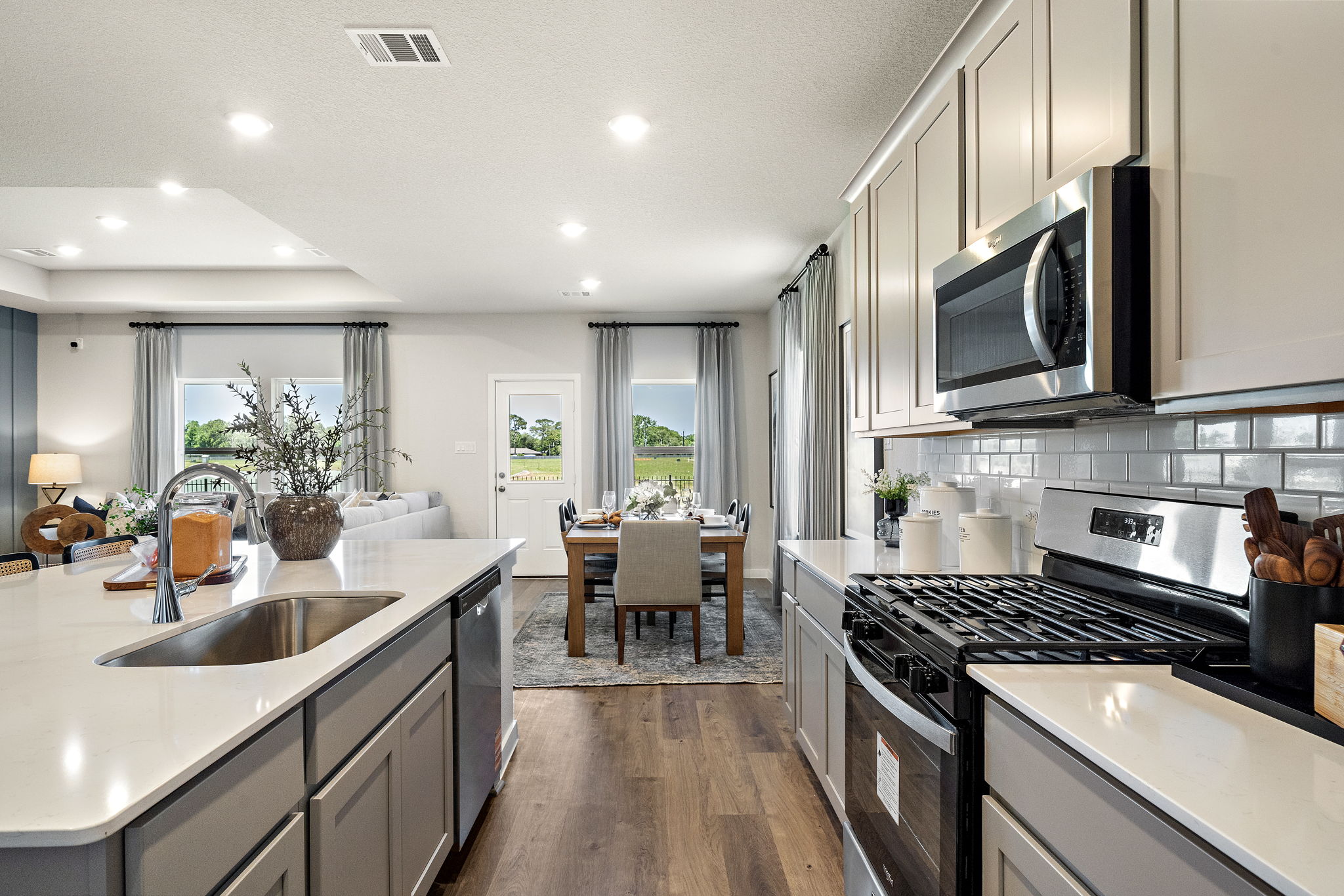 A kitchen with a table and chairs.