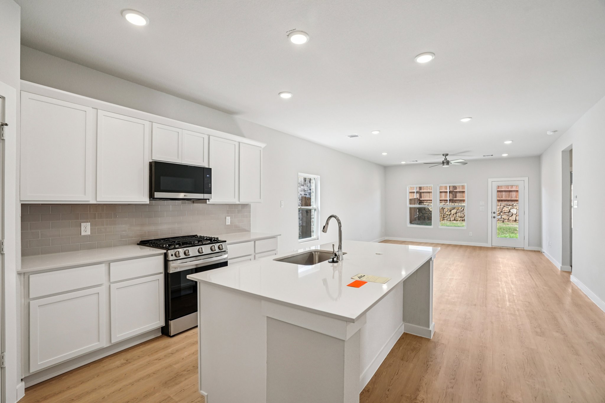 A kitchen with white cabinets.