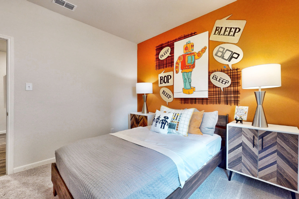 A bed with a blue comforter.