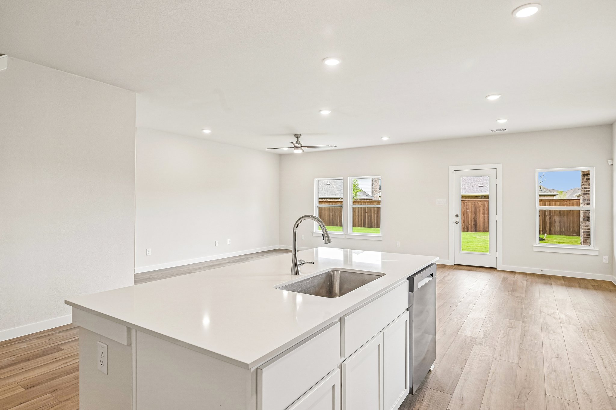 A kitchen with white cabinets.