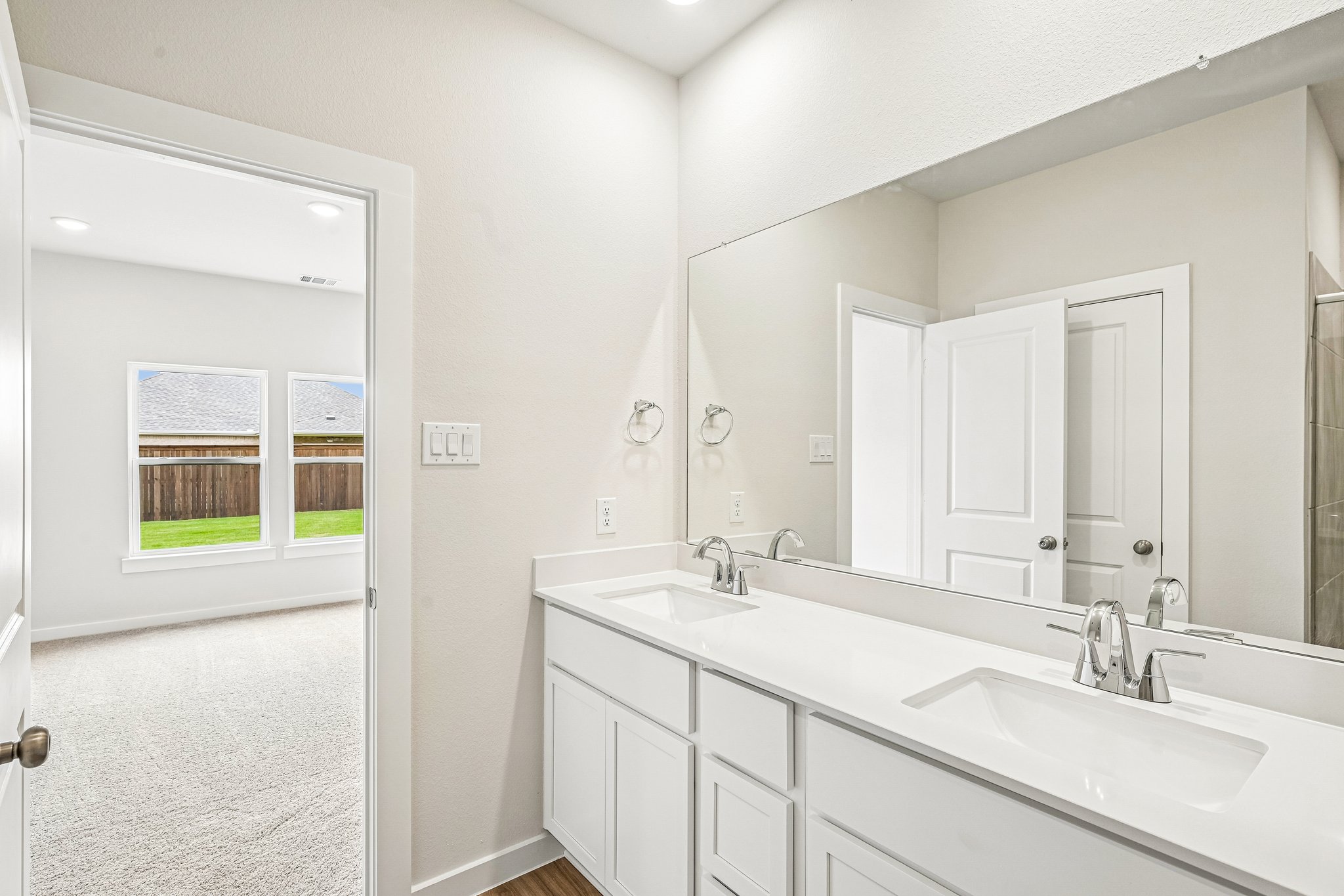 A bathroom with a large mirror.