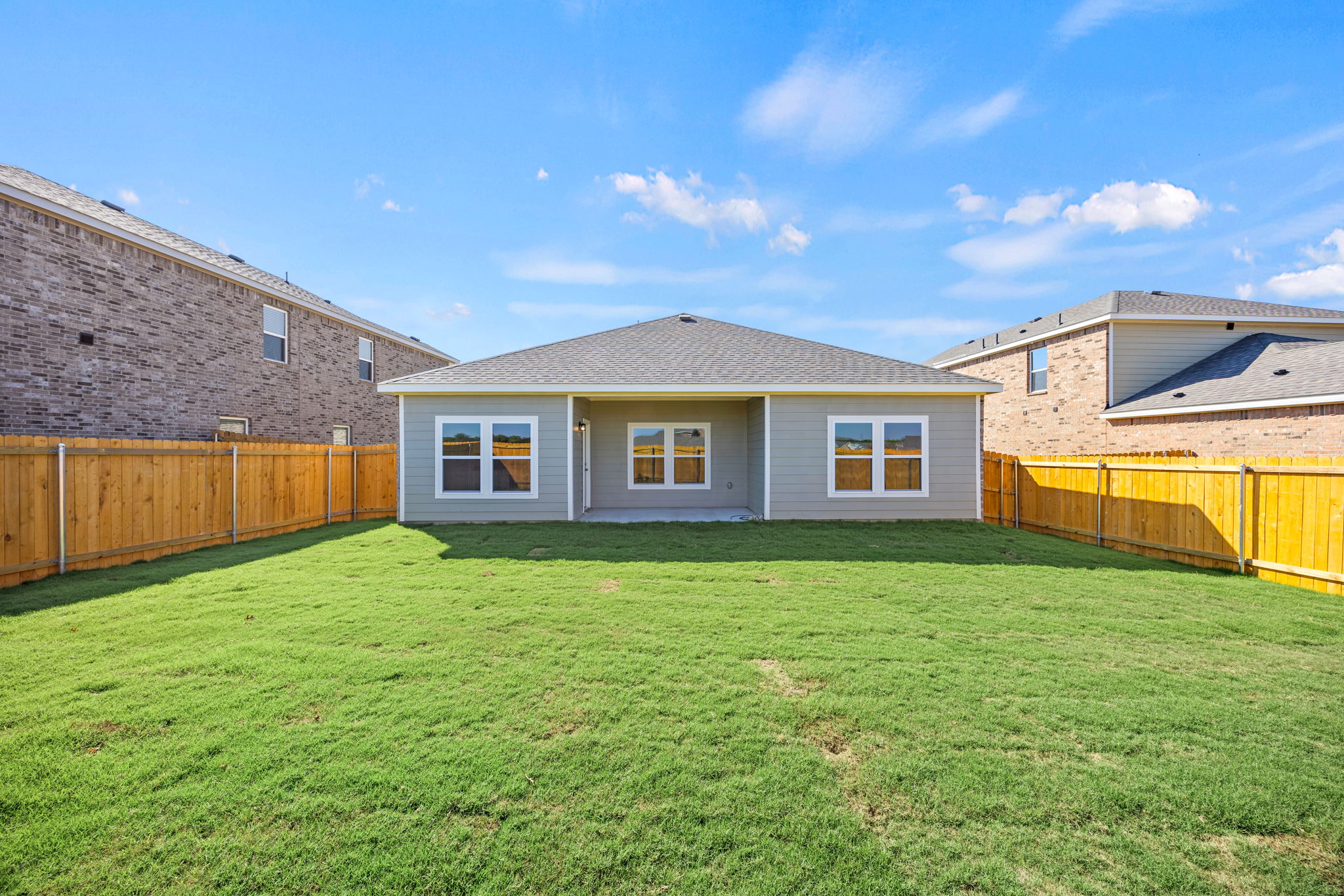 A house with a fence and grass.