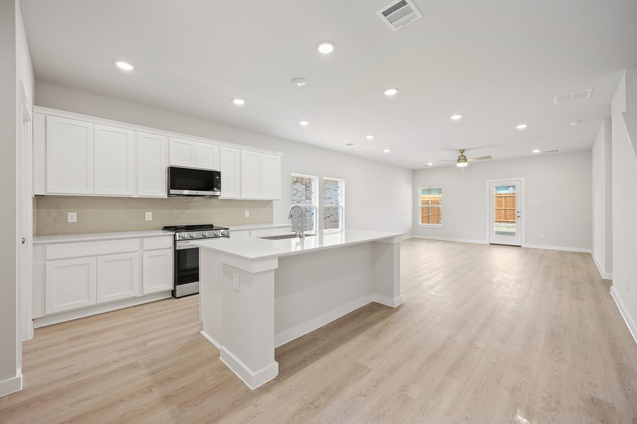 A kitchen with white cabinets.