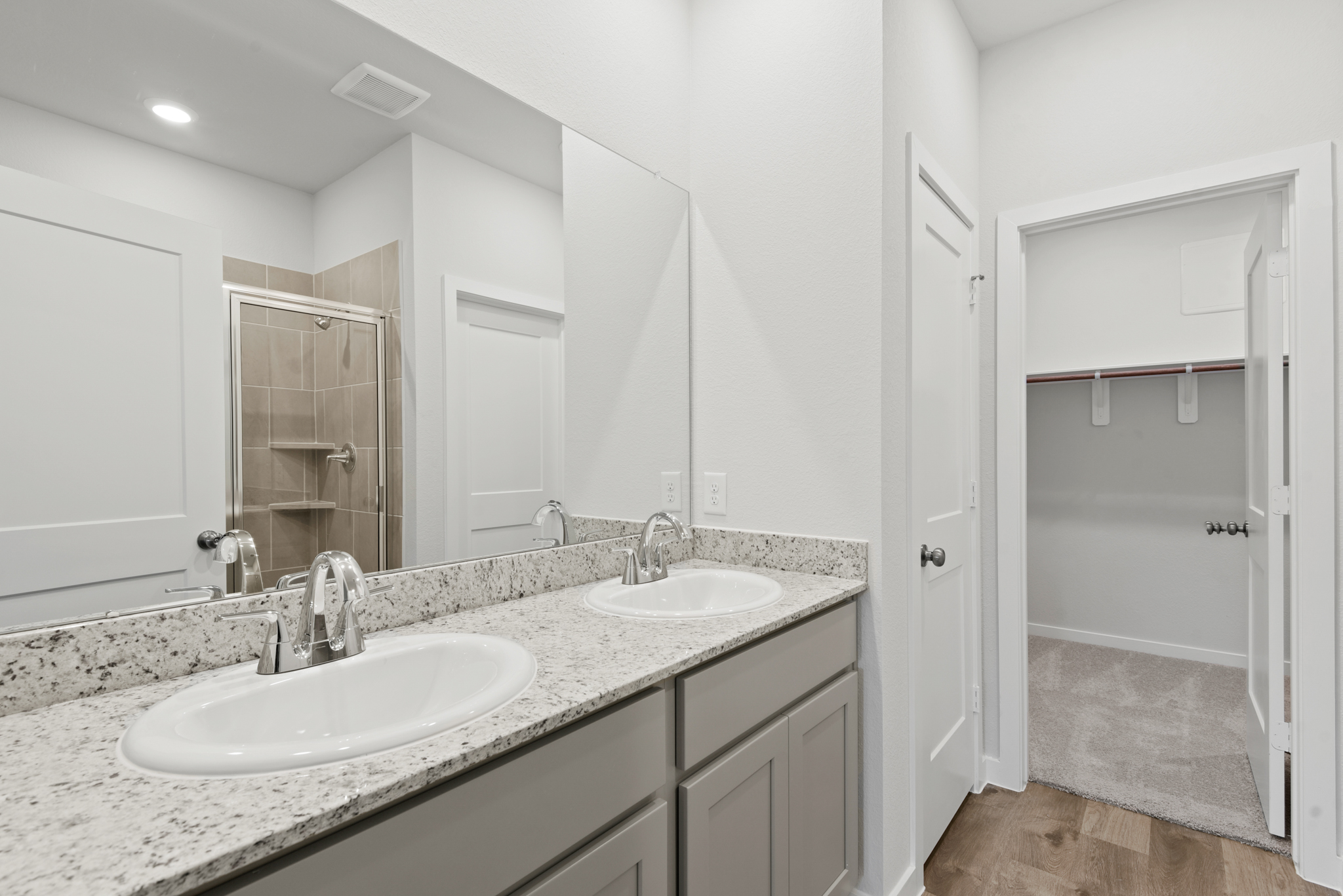 A bathroom with a large mirror.