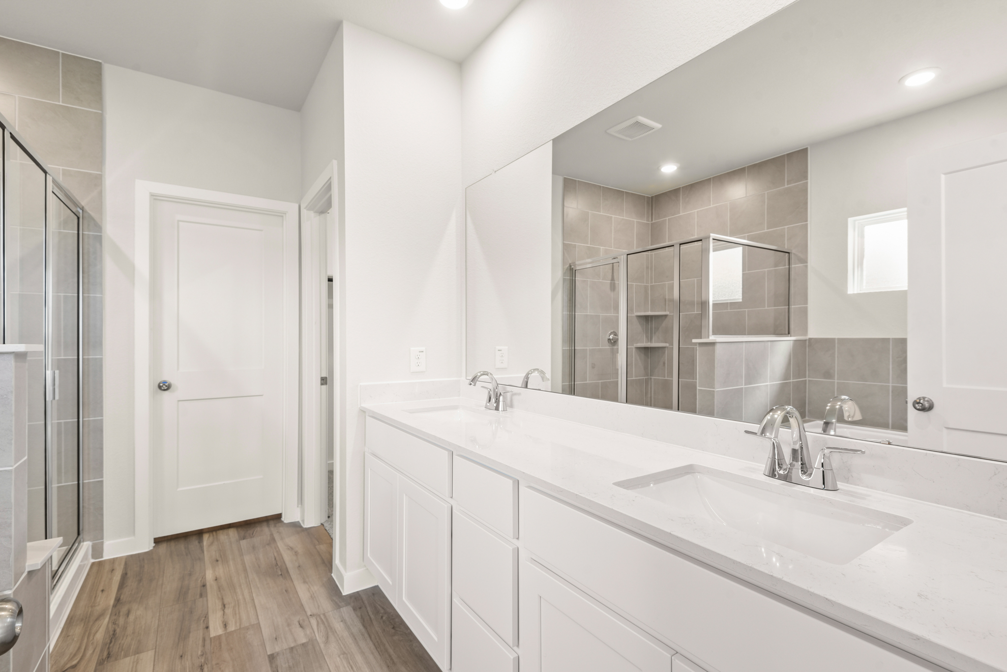 A bathroom with a large mirror.