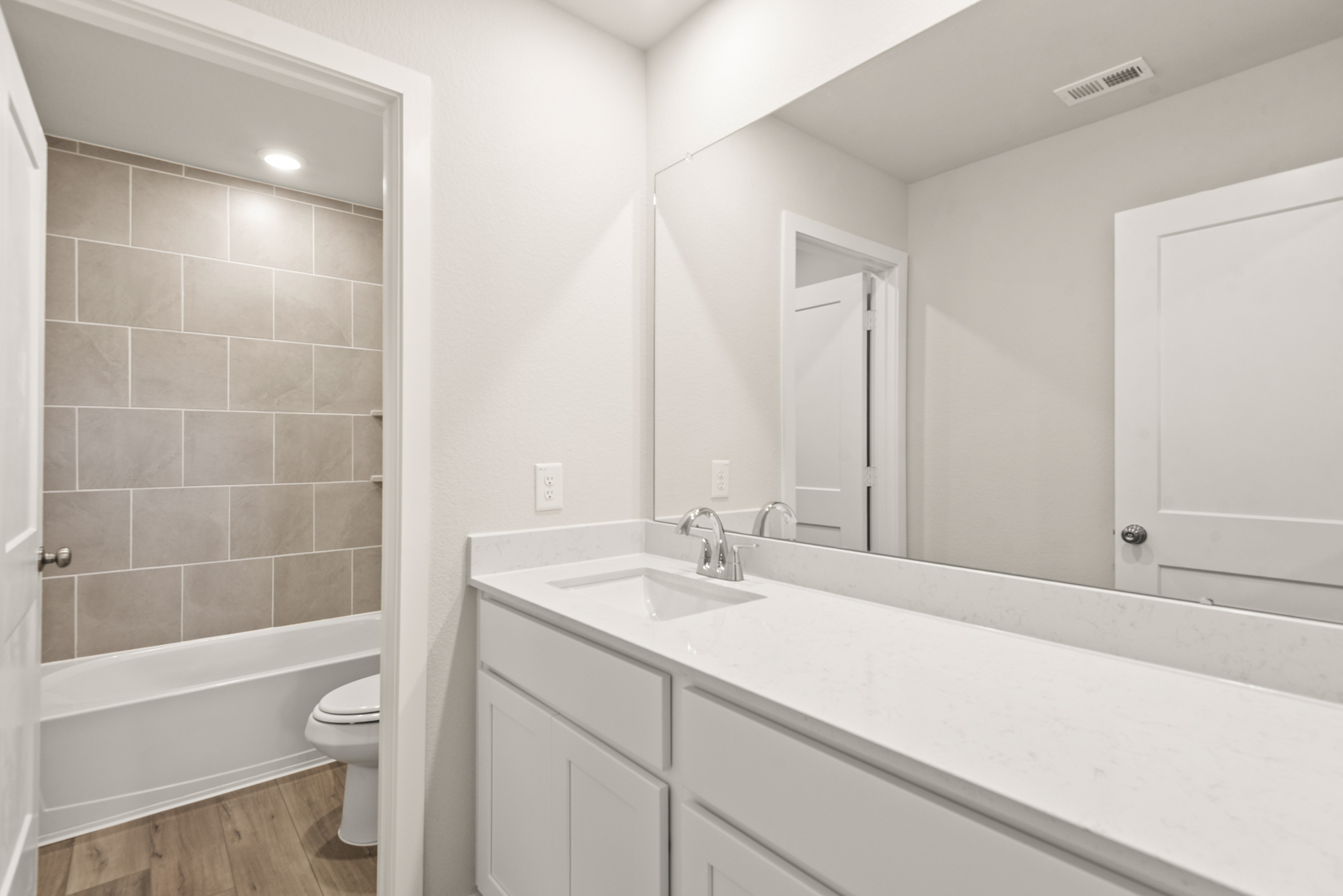 A bathroom with a tub sink and toilet.