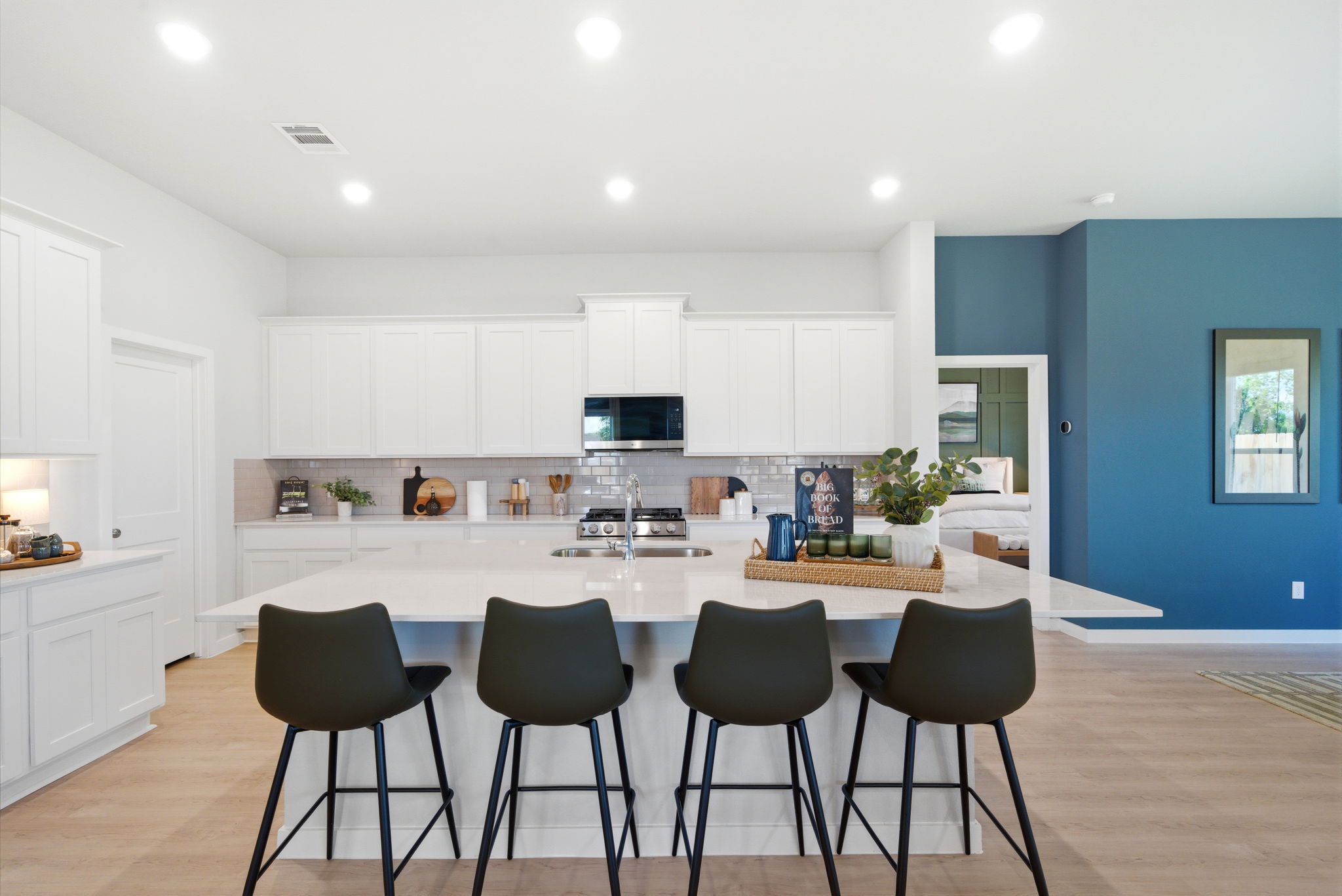 A kitchen with a table and chairs.