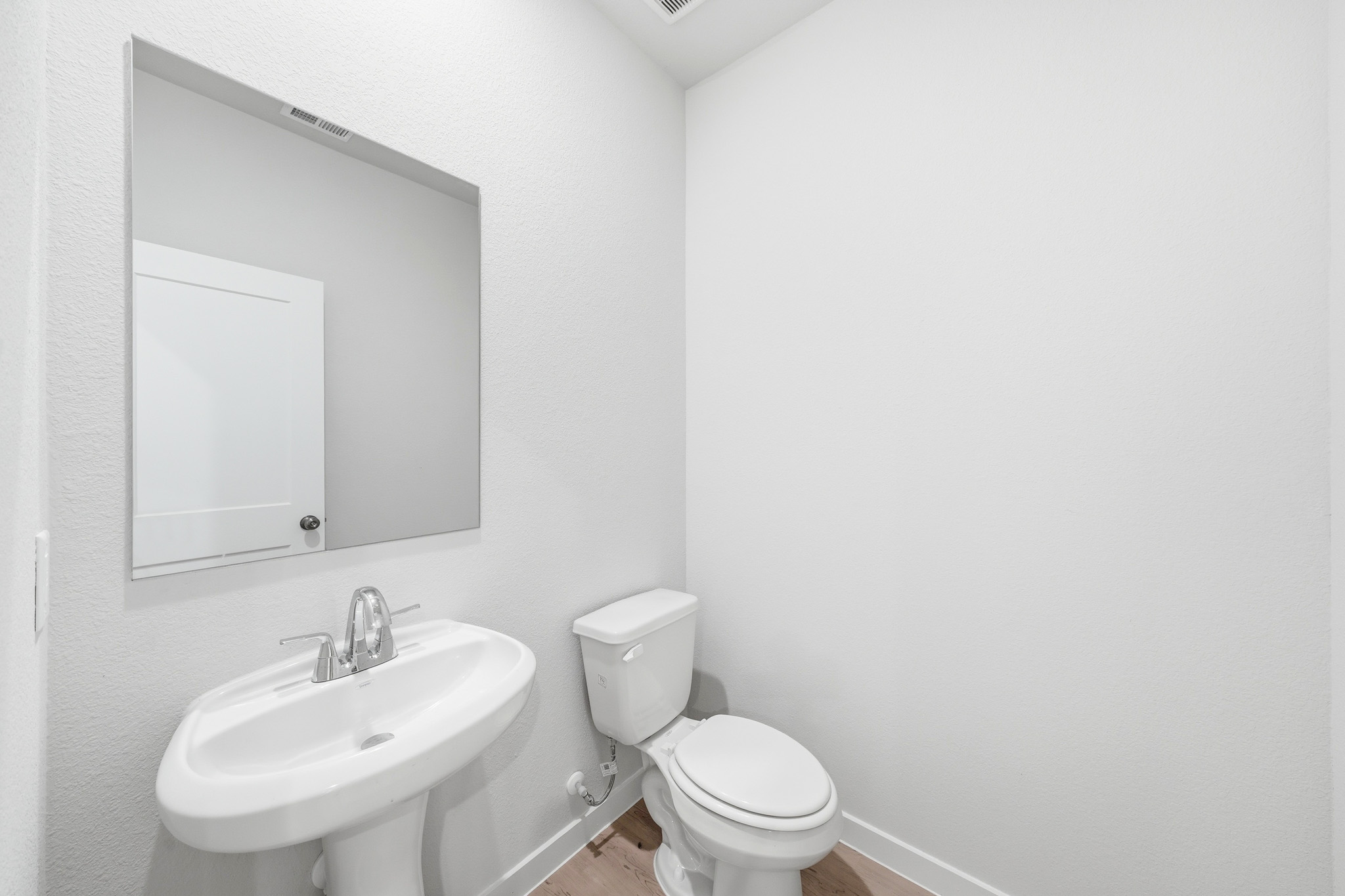 A bathroom with a toilet and sink.
