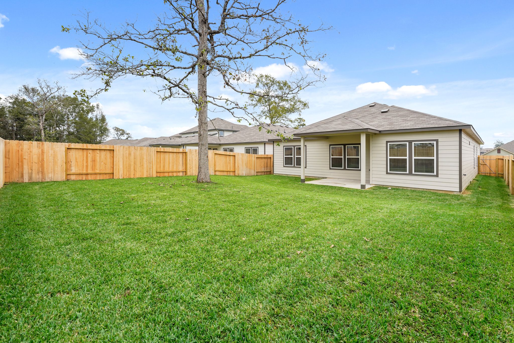 A house with a fence and trees.
