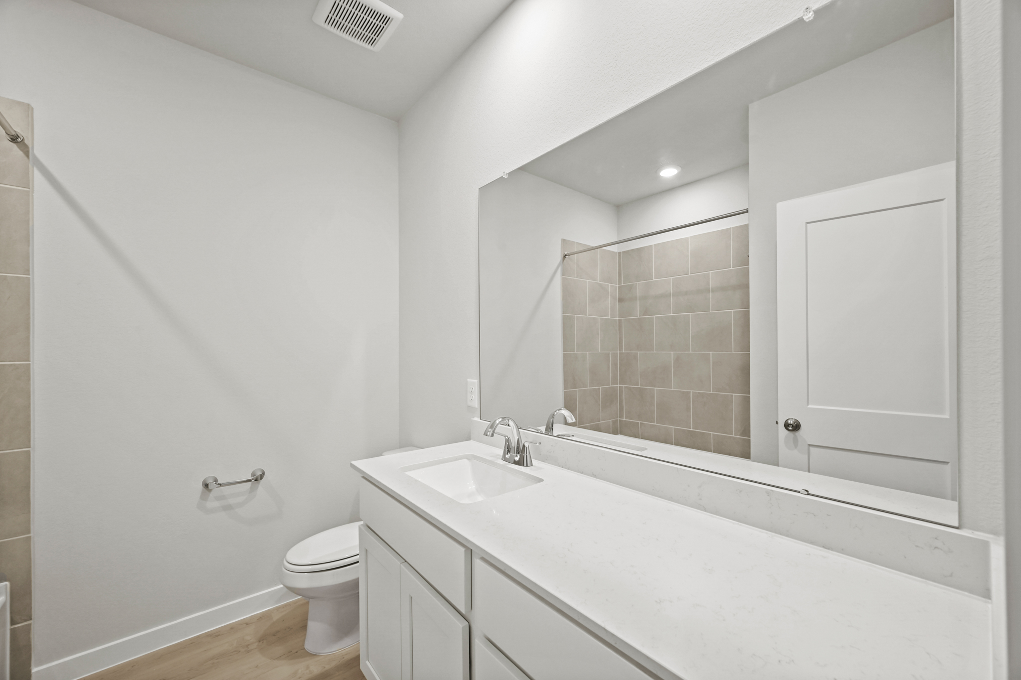 A bathroom with a tub sink and toilet.