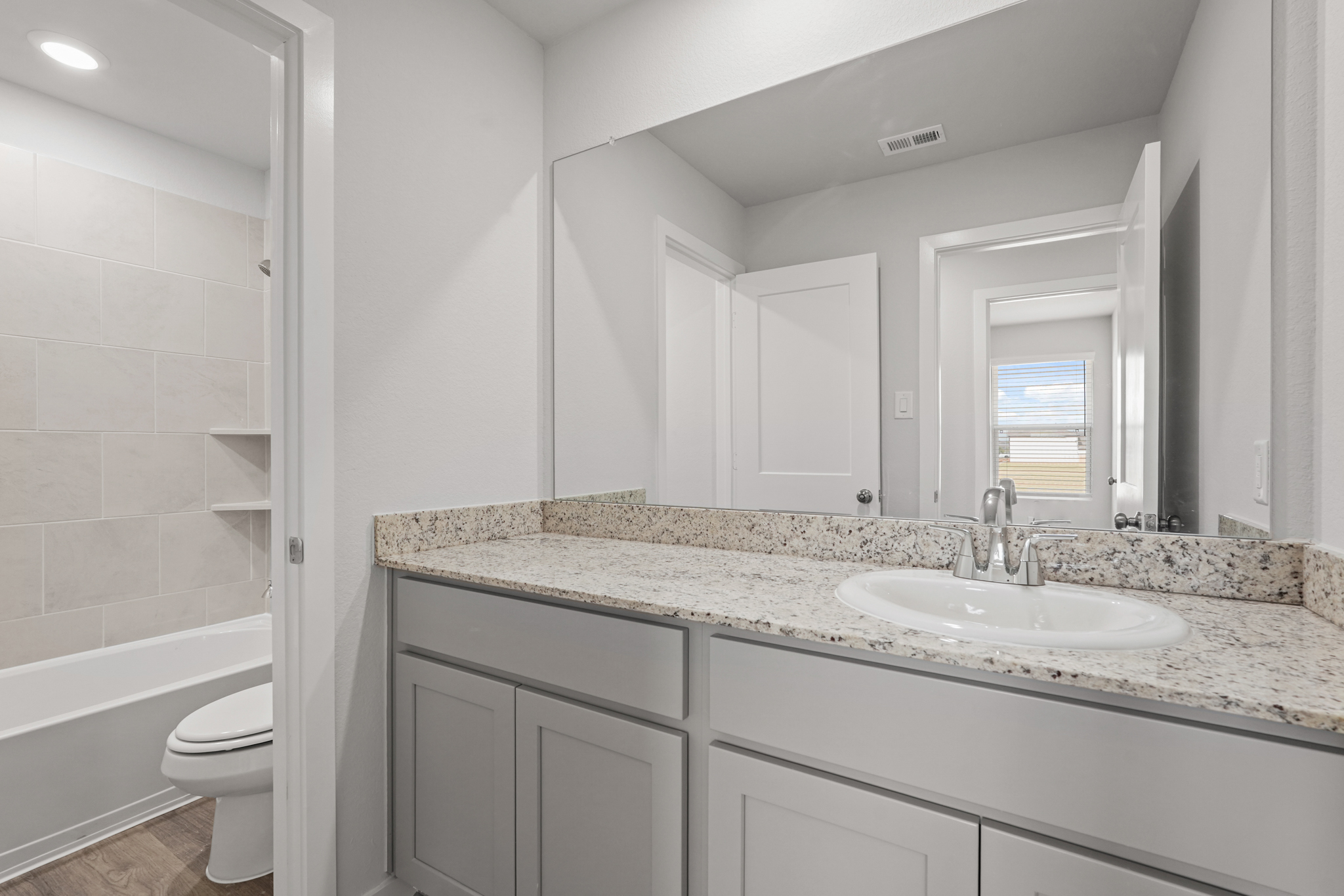 A bathroom with a marble countertop.