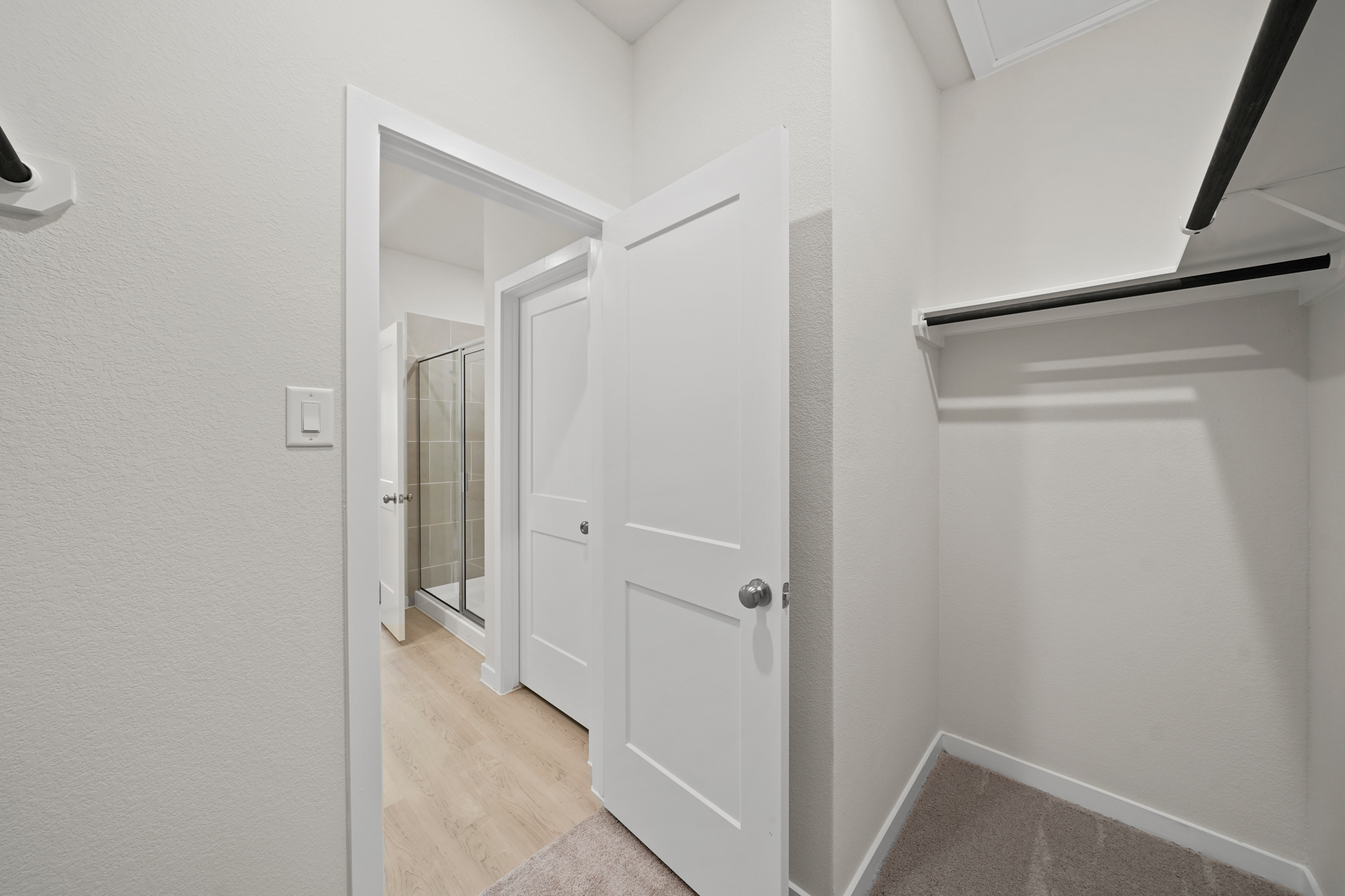 A hallway with white doors.
