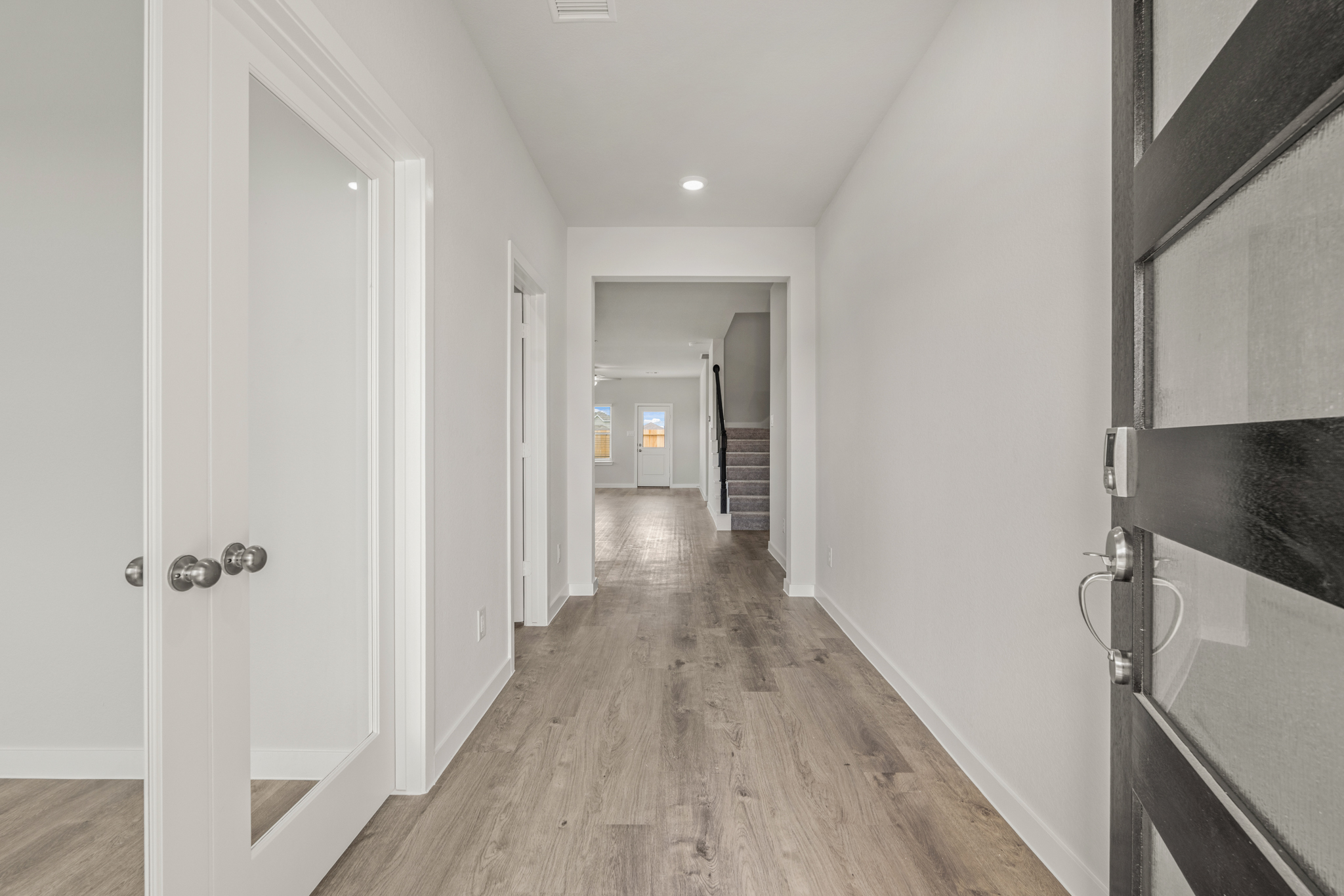 A hallway with white walls.