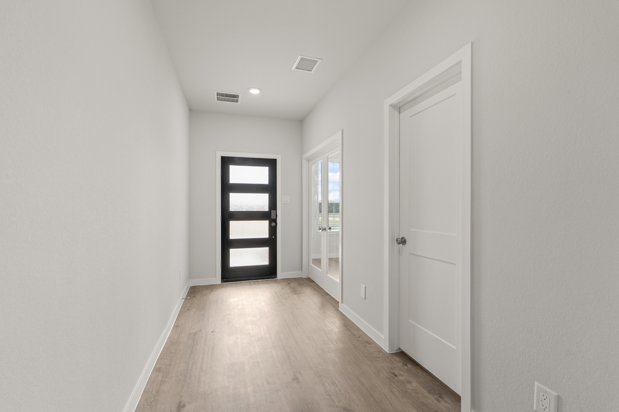 A hallway with white doors.