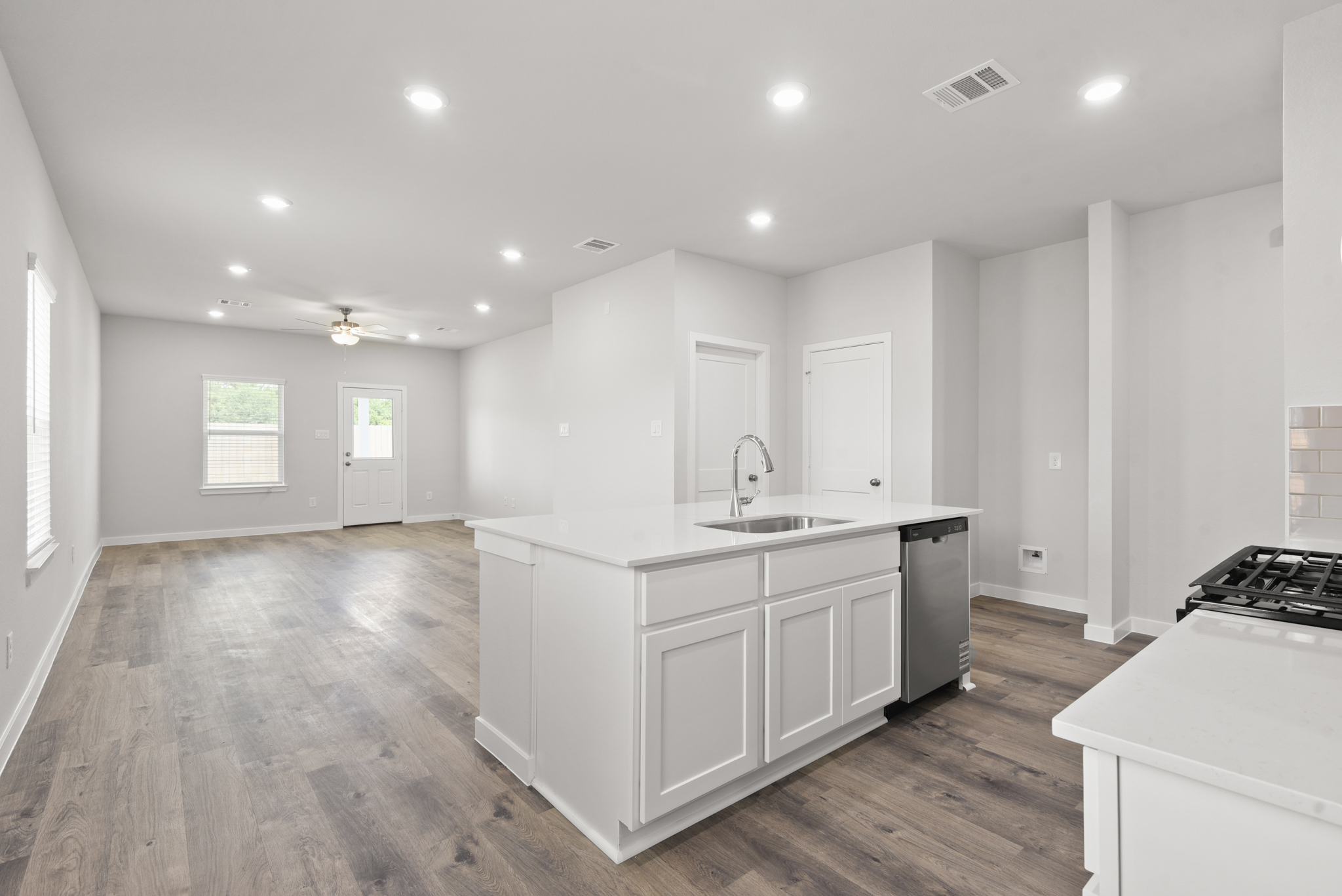 A kitchen with white cabinets.