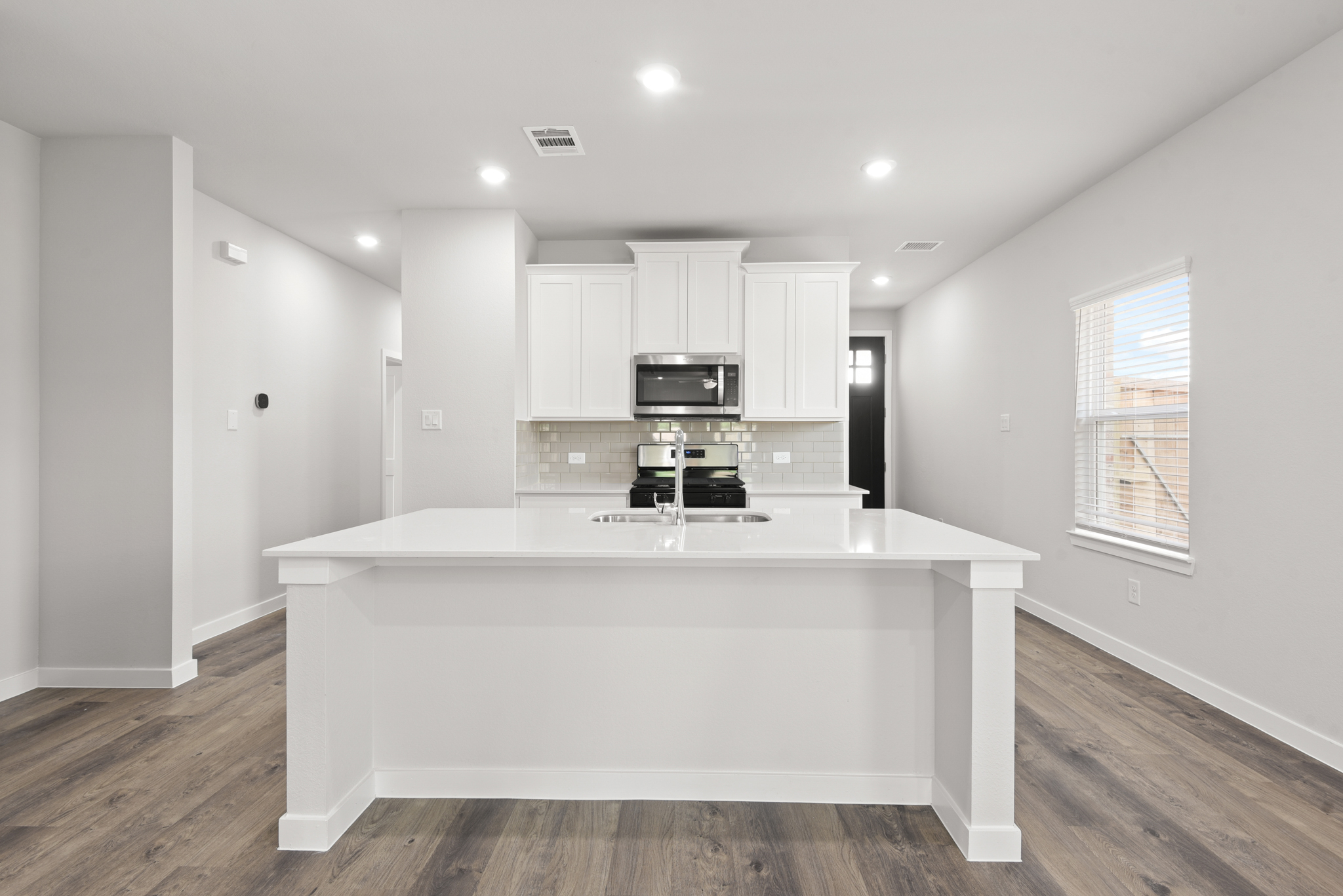 A white kitchen with a white counter.