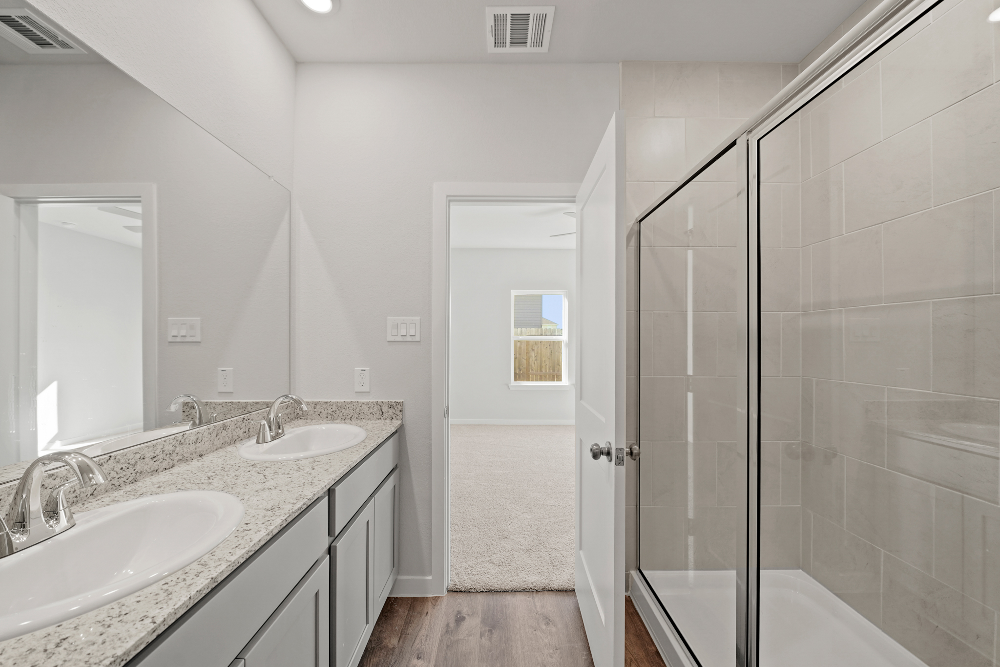 A bathroom with a sink and a shower.