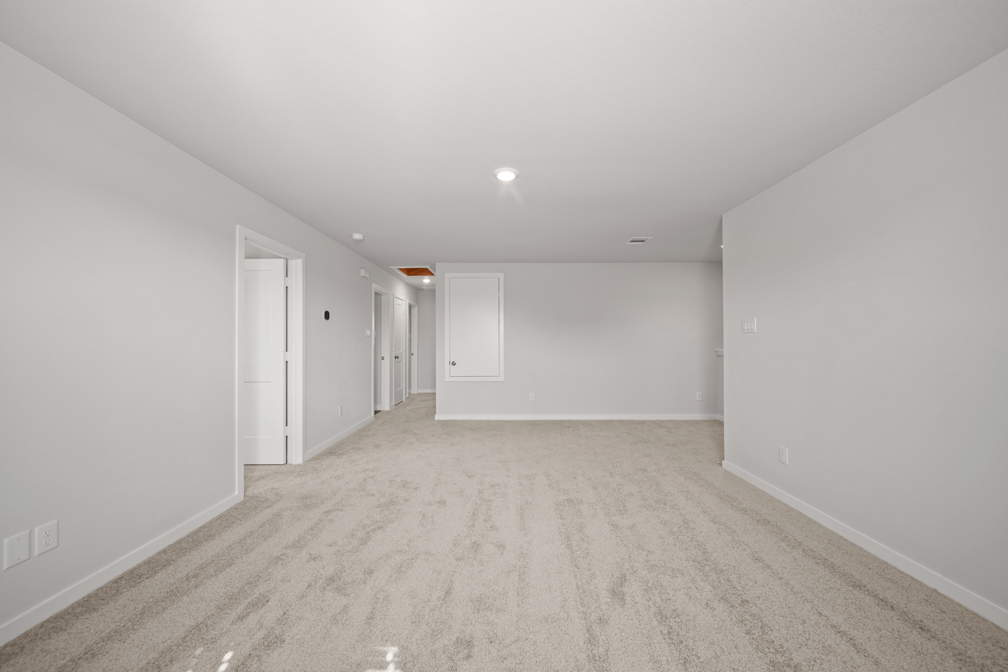 A long hallway with white walls.