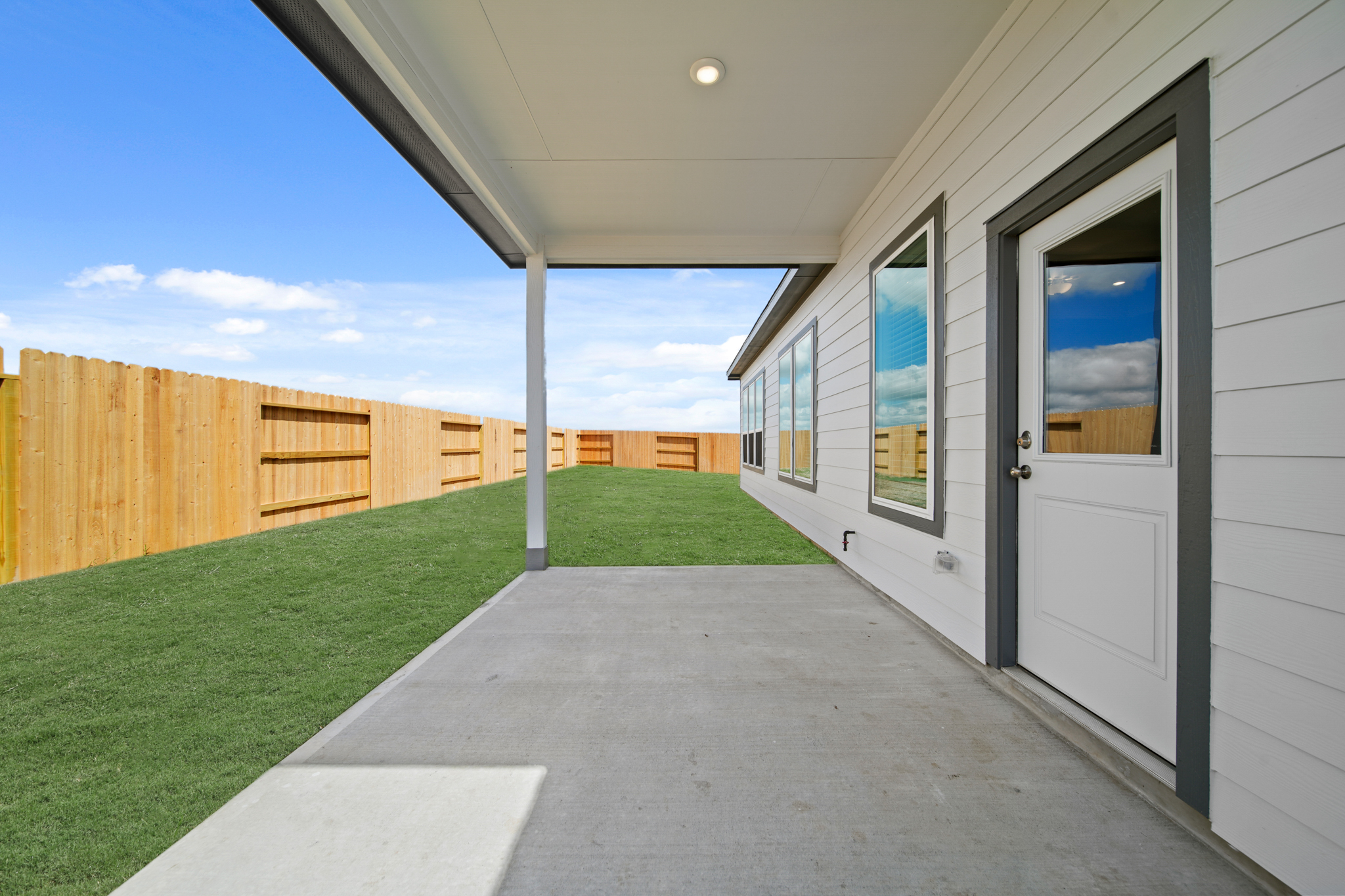 A house with a fence and grass.