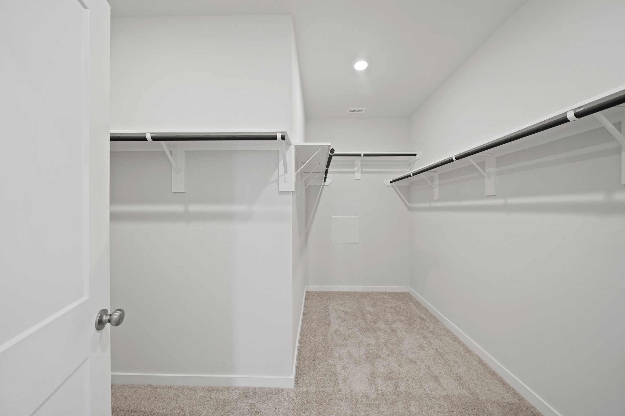 A white room with a white door.