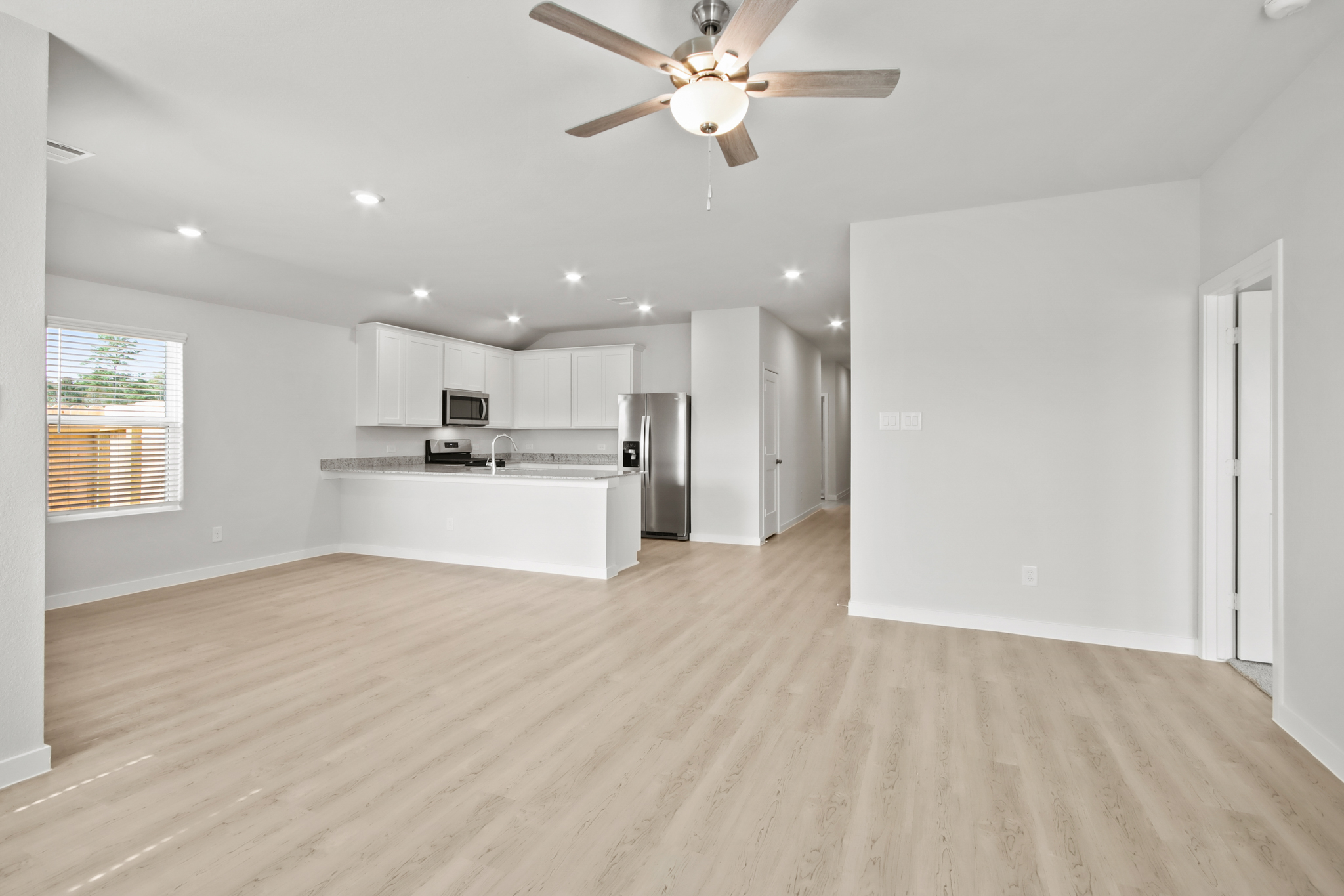 A kitchen with white cabinets.