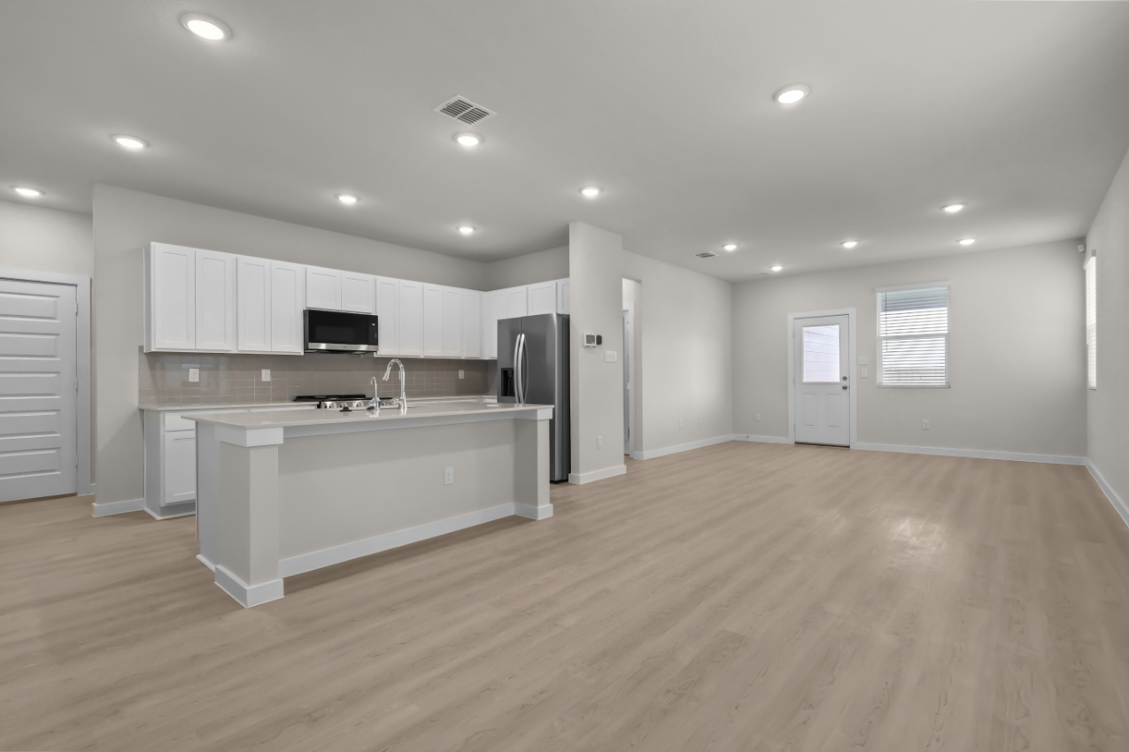 A large kitchen with white cabinets.