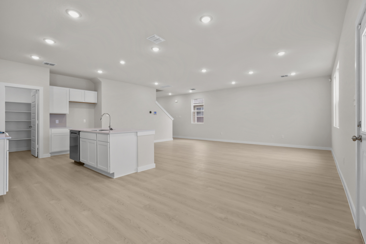 A kitchen with white cabinets.