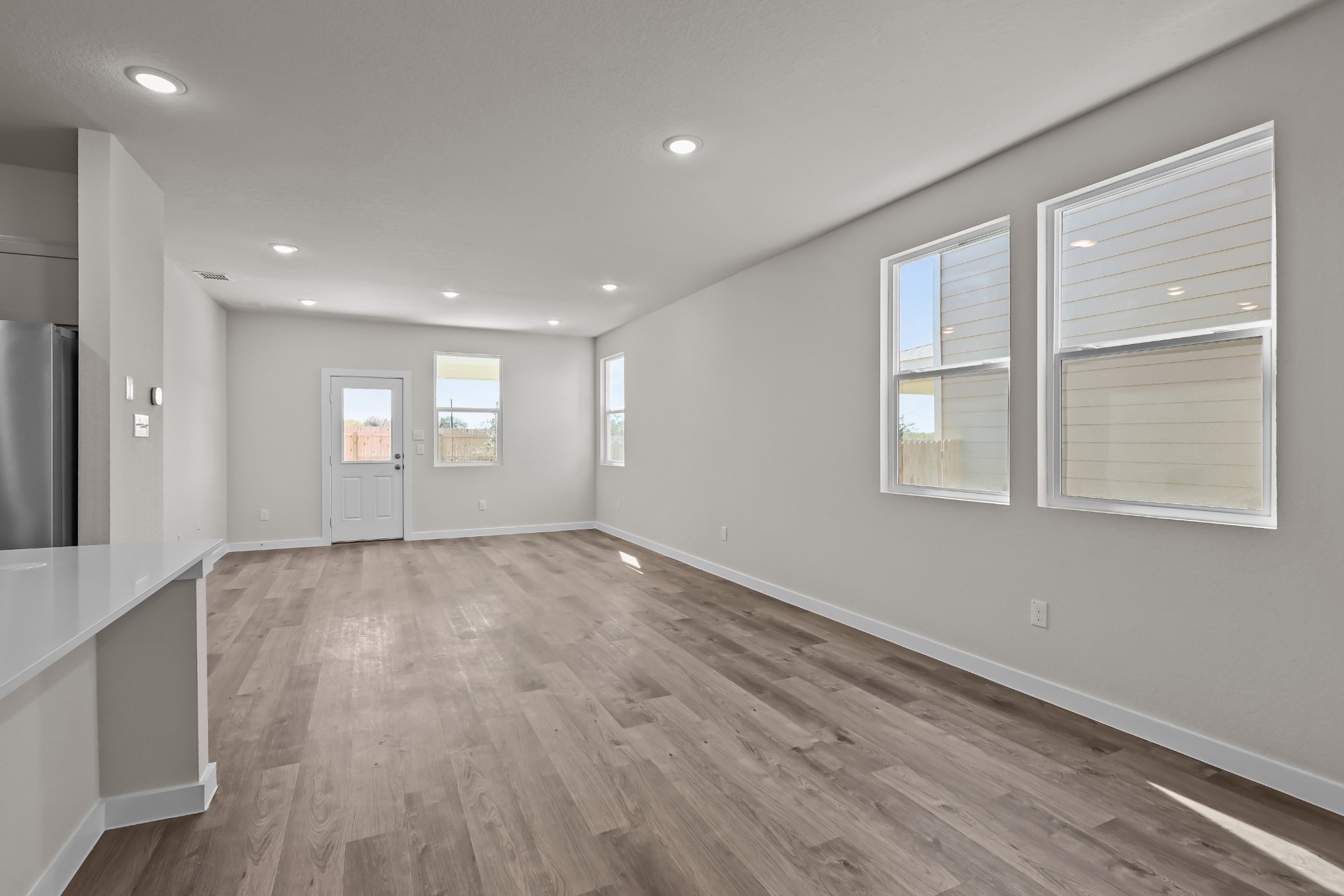 A room with white walls and wood floors.