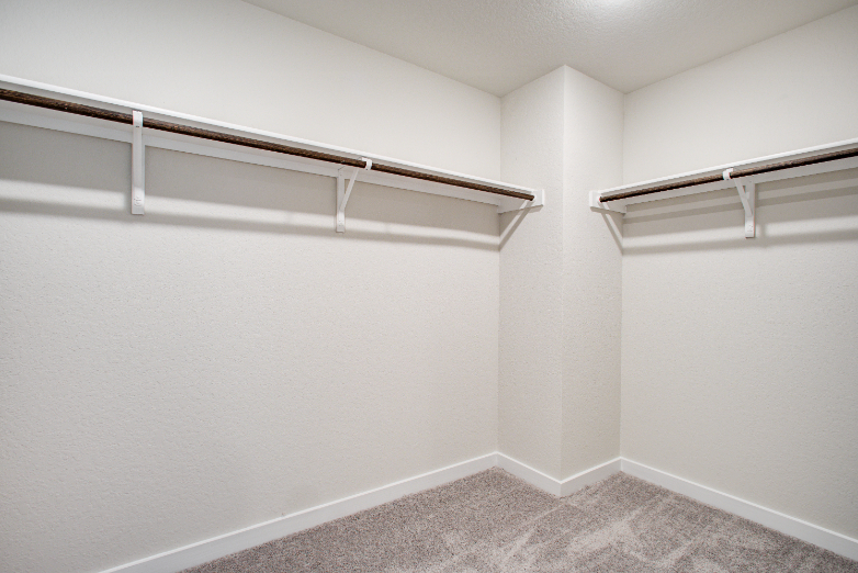 A white room with a carpet.