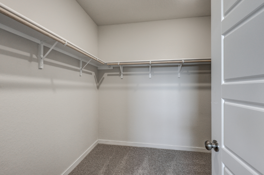 A white room with a metal railing.