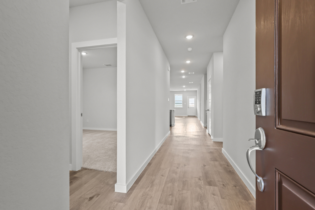 A hallway with white walls.