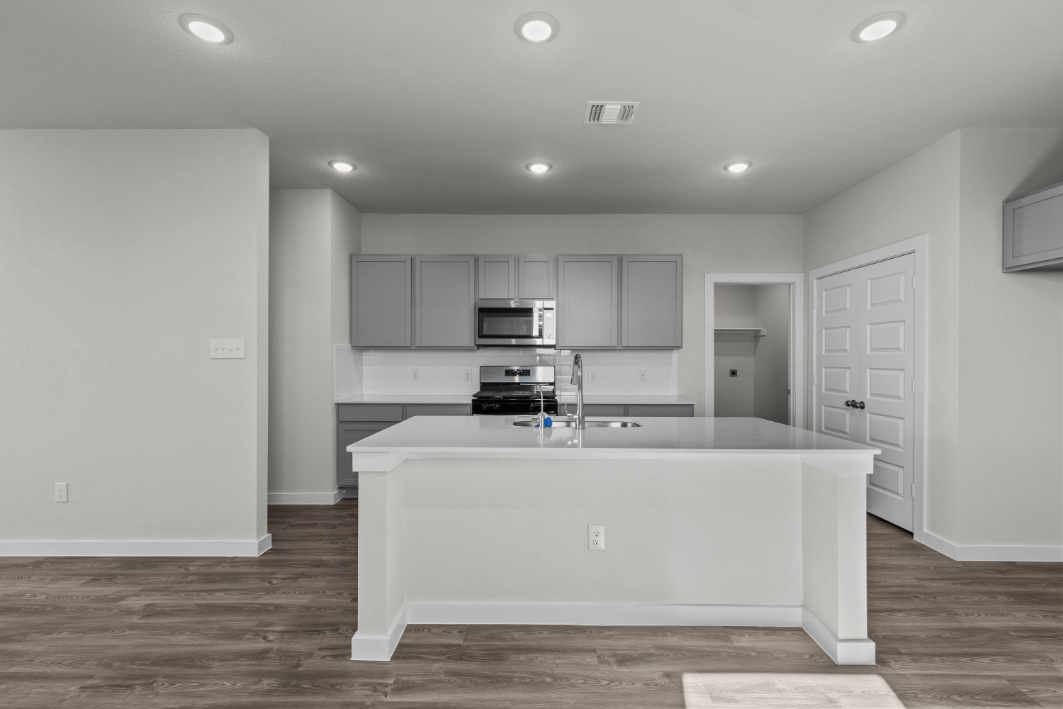 A kitchen with white cabinets.