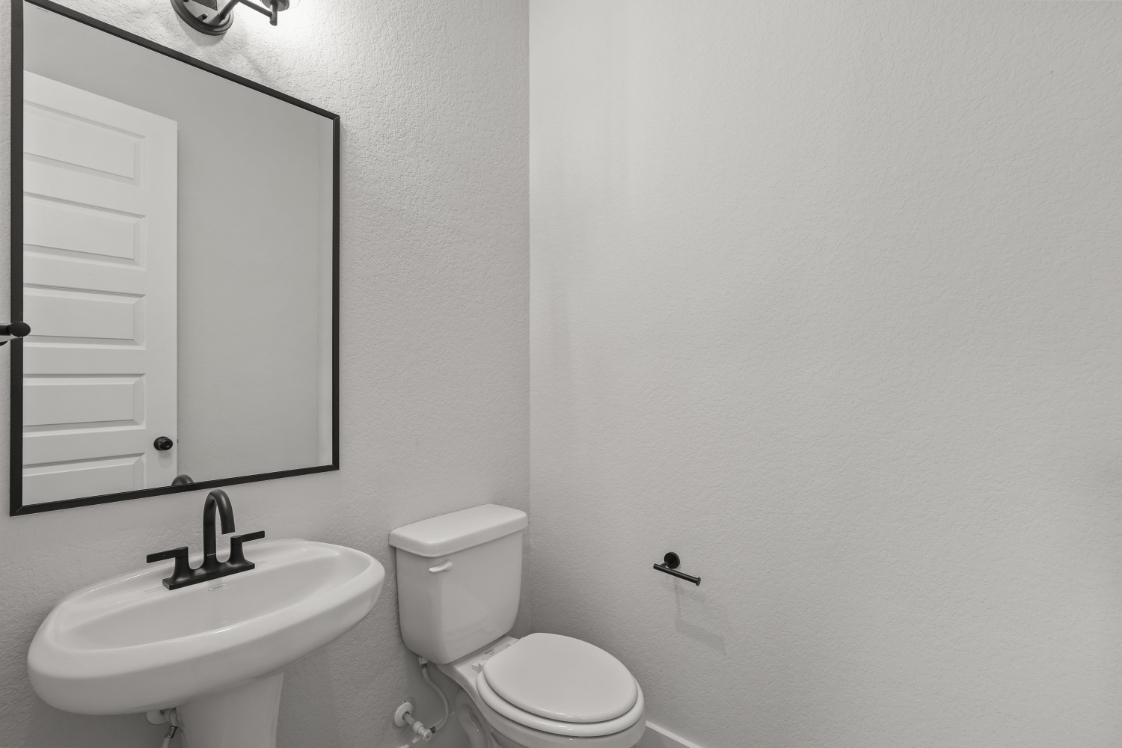 A bathroom with a toilet and sink.