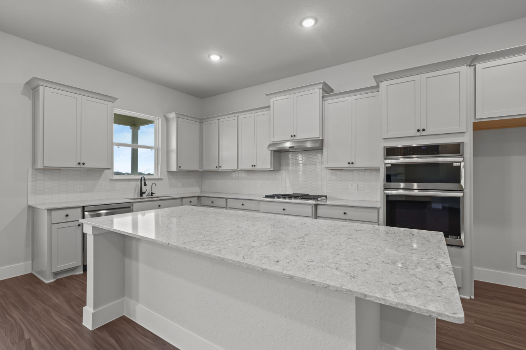 A kitchen with white cabinets.